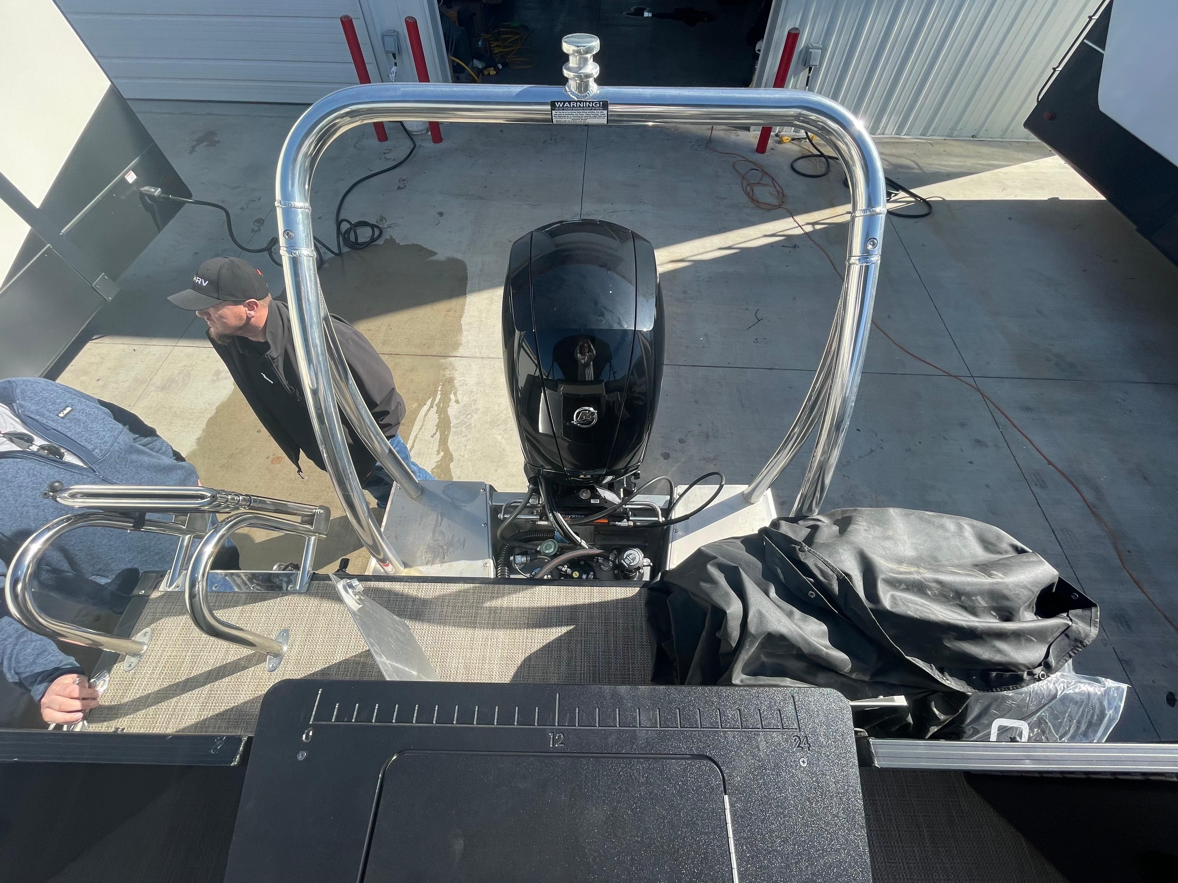 2022 Viaggio Lago boat with motor, viewed from above, in a garage setting.