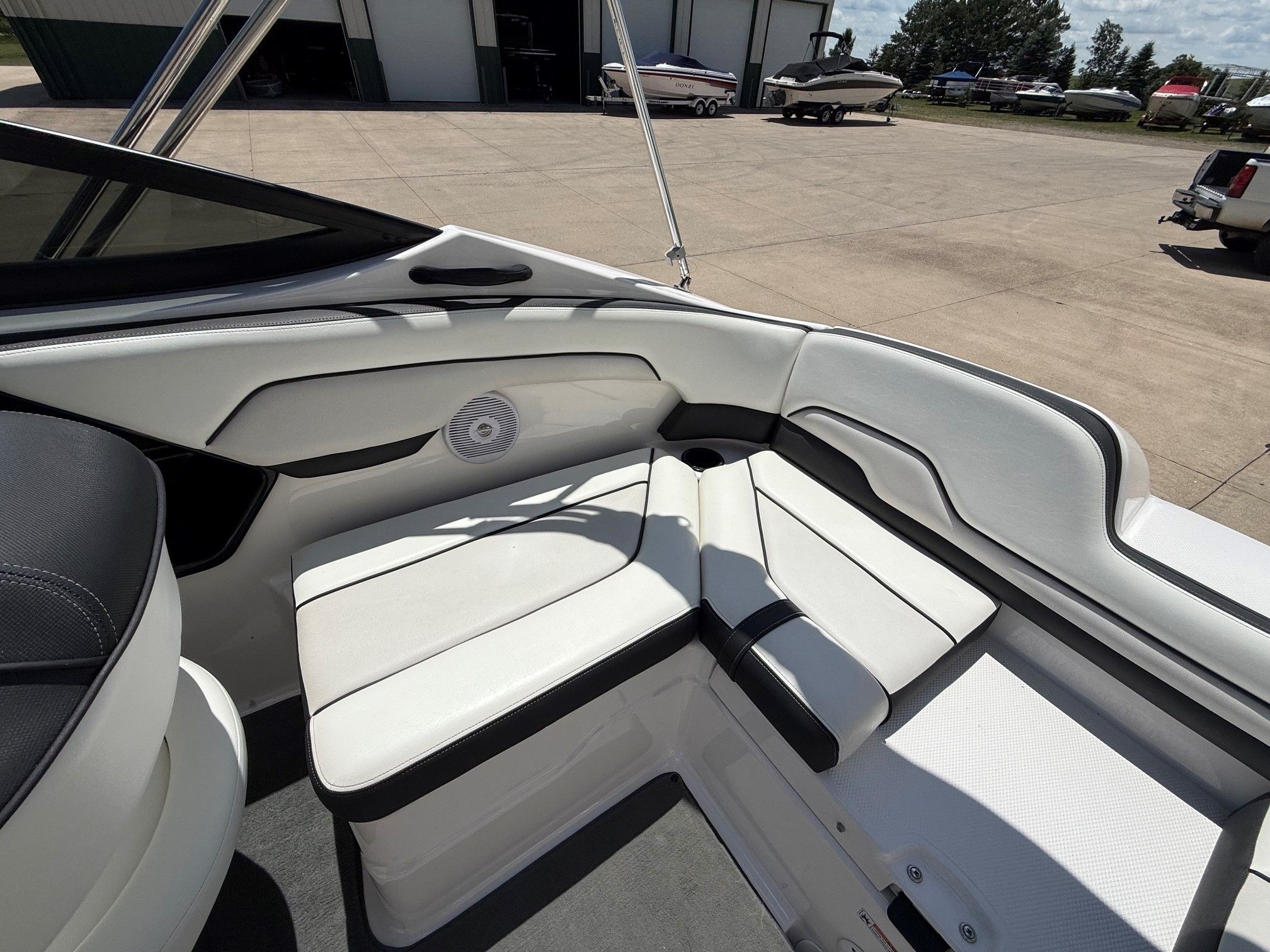 The image shows the interior of a Yamaha SX210 boat with white seating.