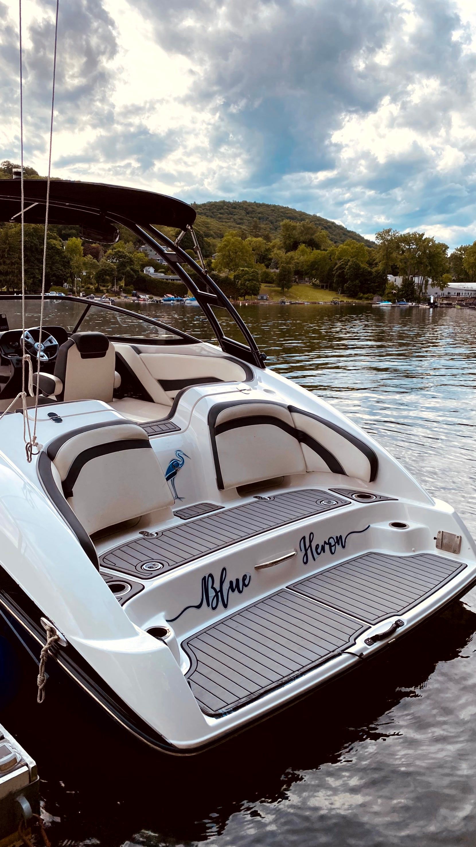 2016 Yamaha AR240 boat on a serene lake with cloudy sky.