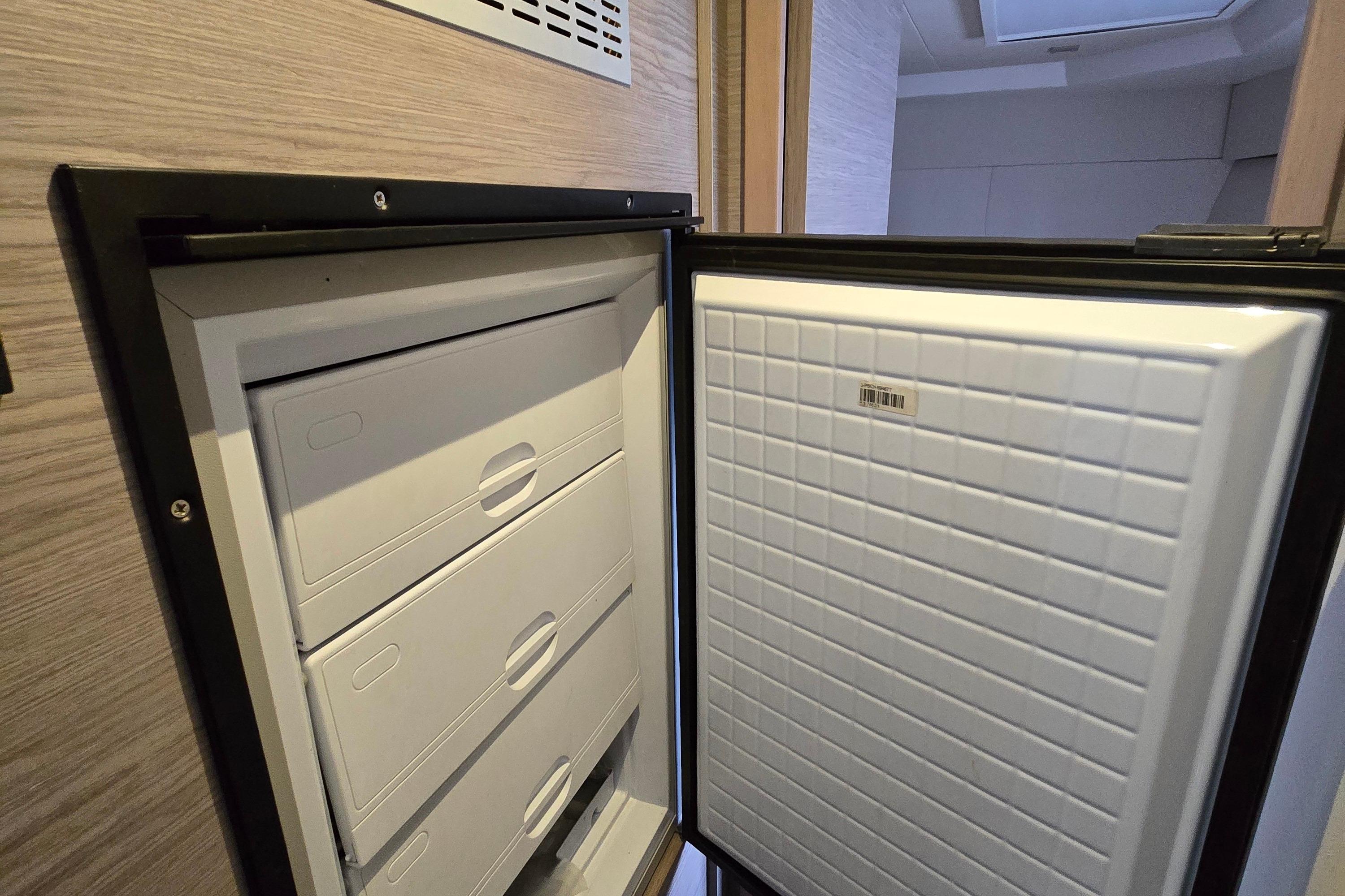 Open refrigerator on 2021 Fountaine Pajot MY4.S yacht, showcasing interior storage drawers.