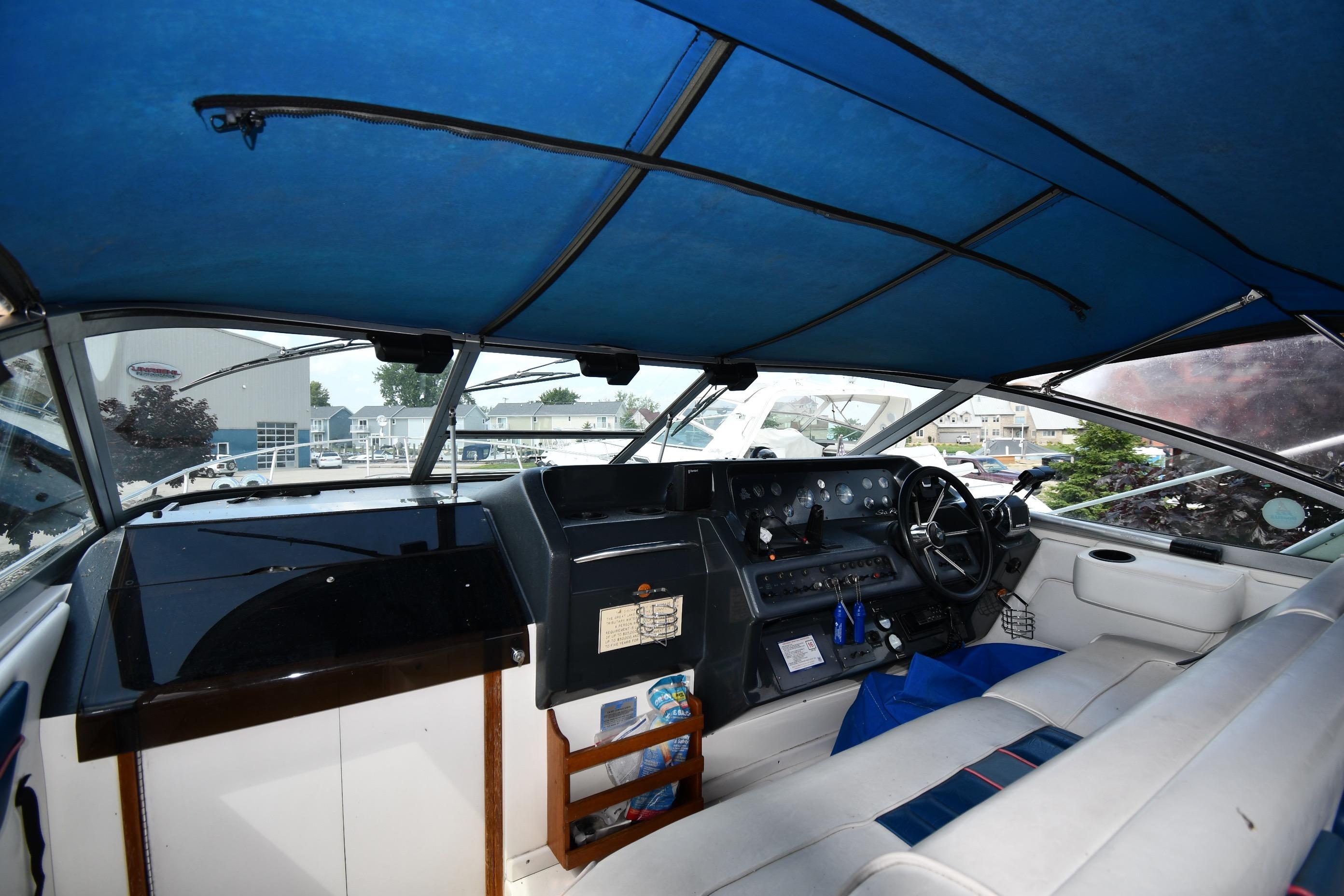 Interior view of a 1993 Sea Ray 300 Sundancer boat cockpit with blue canopy.