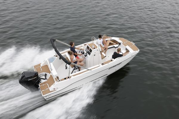 2025 Starcraft SVX 211 OB CC boat cruising on open water with passengers.
