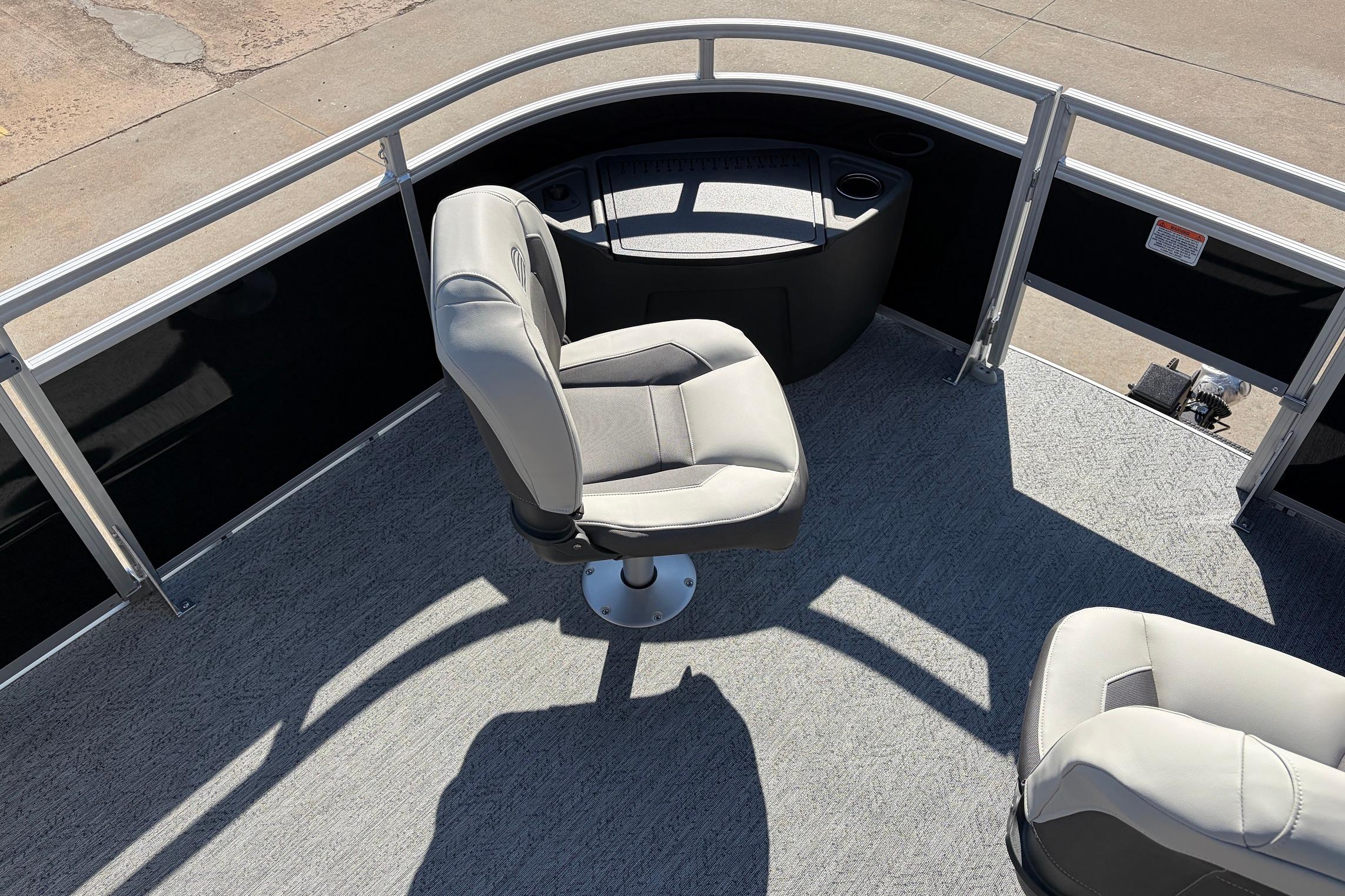 2026 Sun Tracker Fishin' Barge 22 XP3 interior with swivel seats and console.