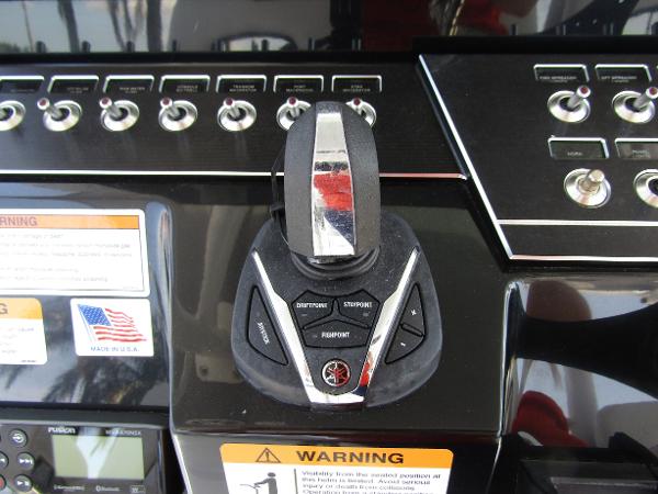 Control panel of 2024 Wellcraft 352 Fisherman boat with joystick and switches.