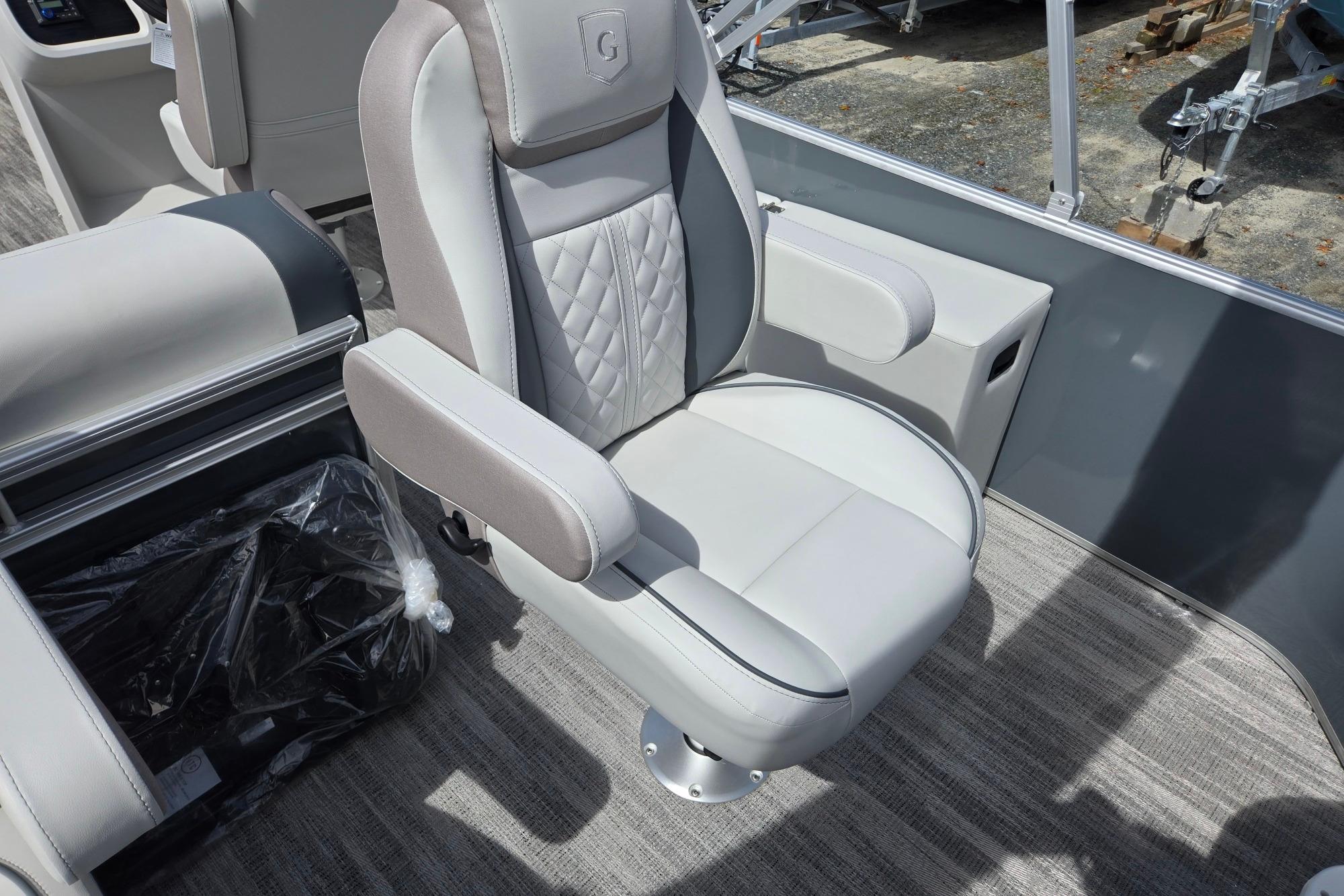 Captain's chair in 2026 Godfrey Sweetwater 2286 FS boat, featuring luxurious upholstery and armrests.