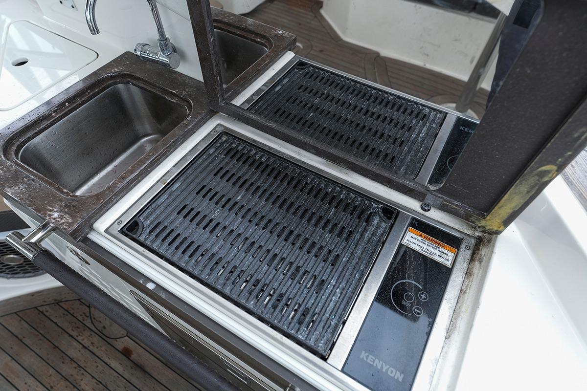 Outdoor kitchen area on 2018 Sea Ray SLX 350 boat with sink and grill.