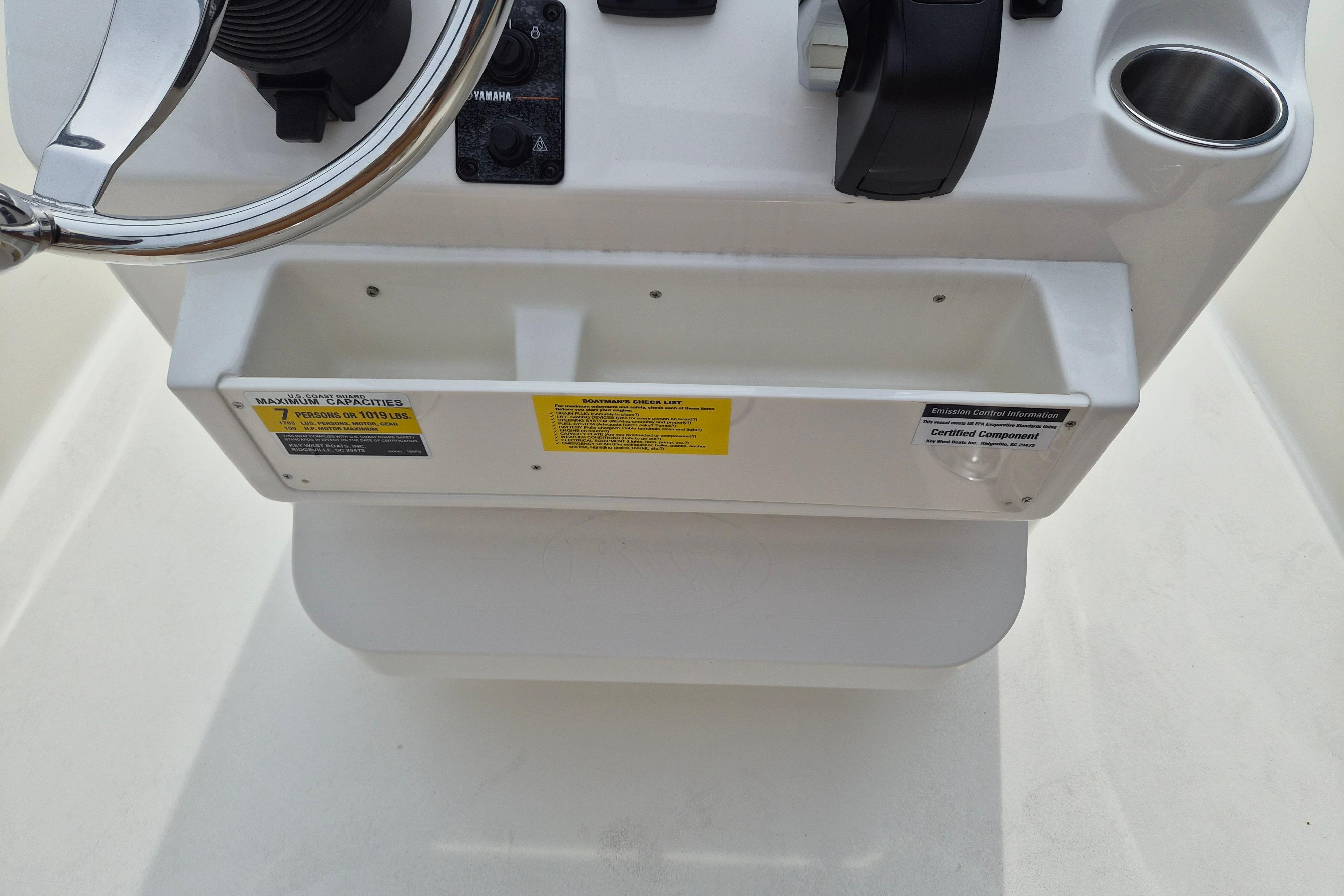 Console of 2026 Key West 189 FS boat with steering wheel and controls.