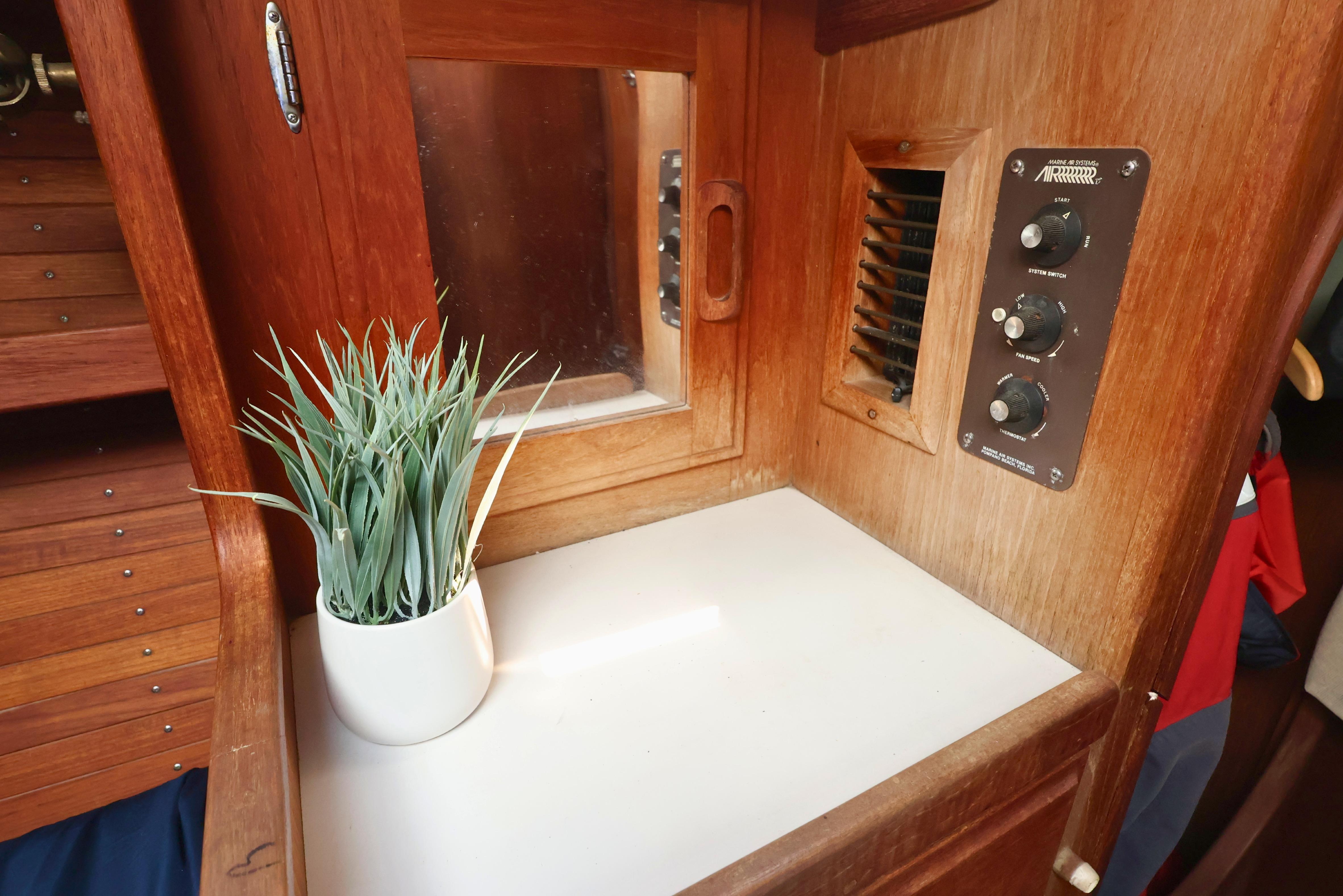 Interior of 1989 J Boat J 40 with wooden paneling and potted plant.