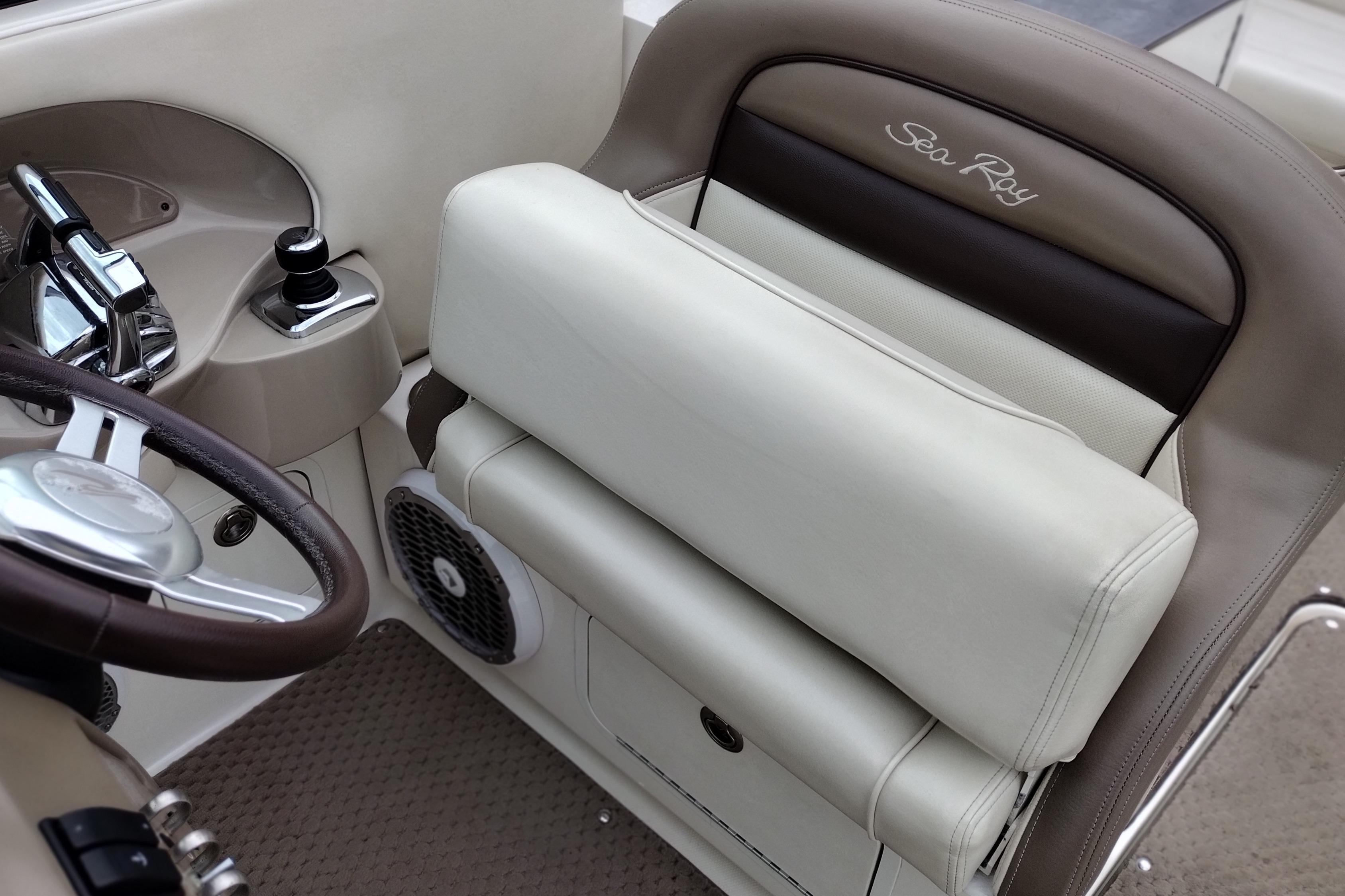 2013 Sea Ray 300 SLX boat interior with steering wheel and beige seating.