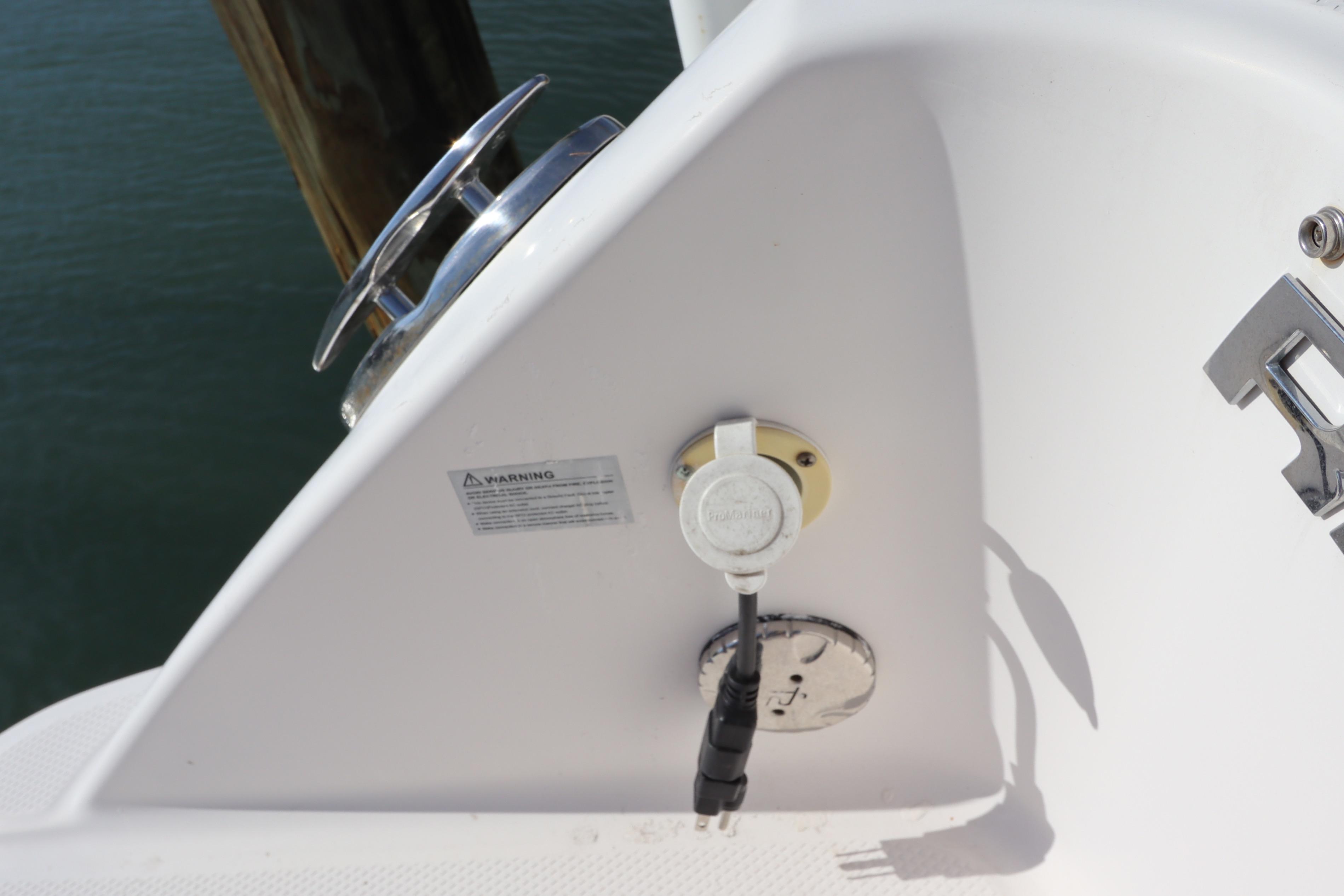 2019 Robalo R242 Center Console boat detail with cleat and power connection.