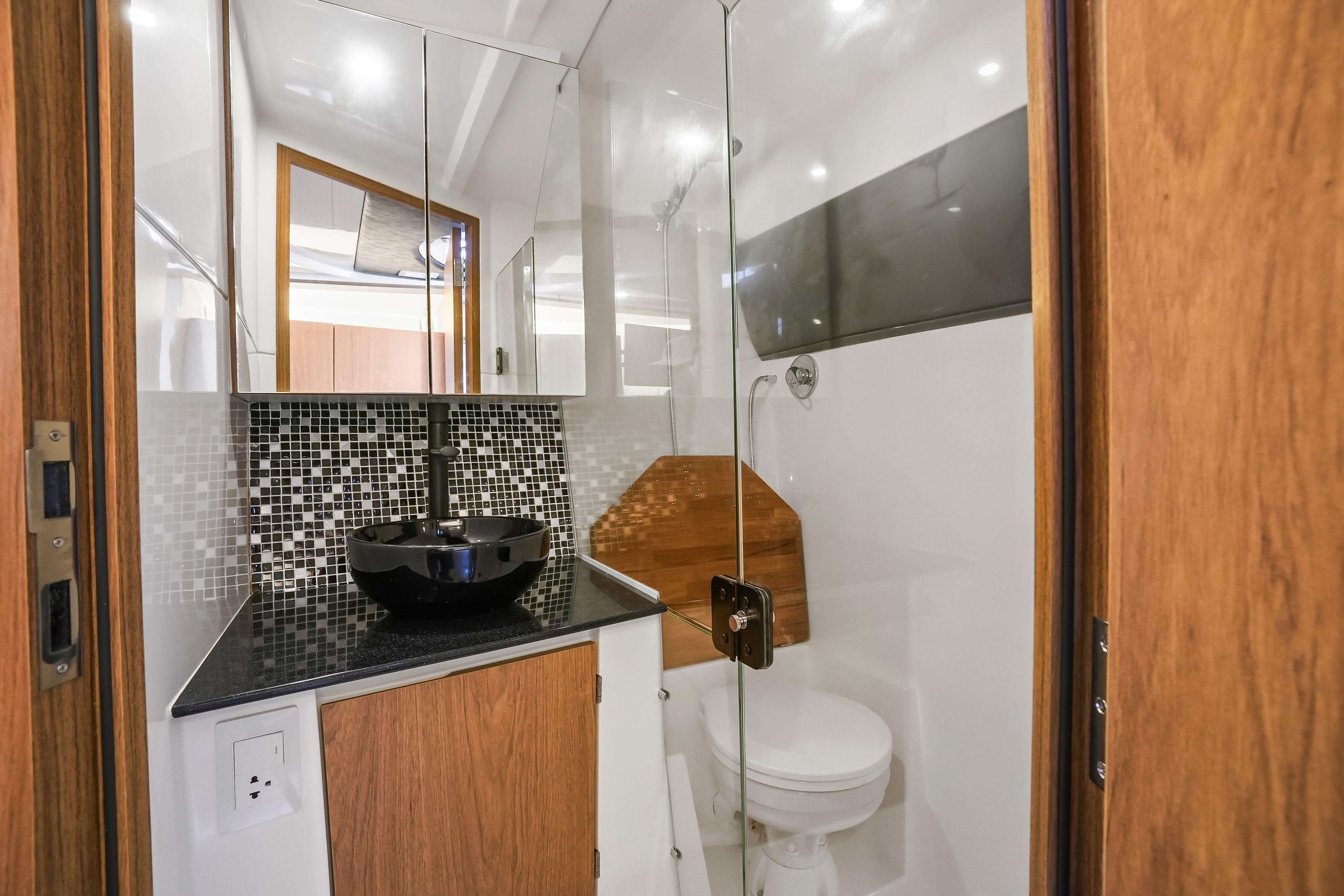 Modern bathroom in 2026 Hanover 355 RV with sleek design and glass shower.