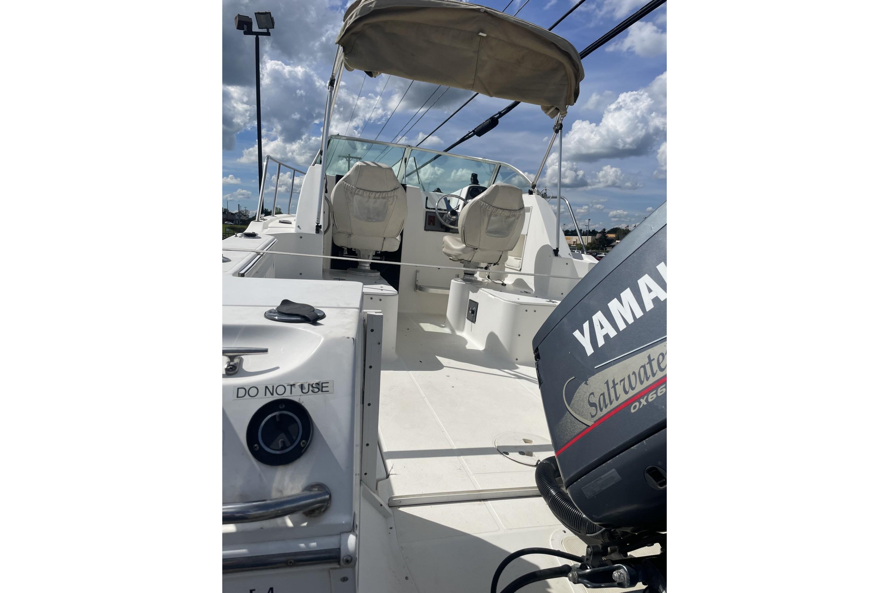2002 Wellcraft 24 Walkaround boat with Yamaha outboard motor, featuring spacious deck and seating.