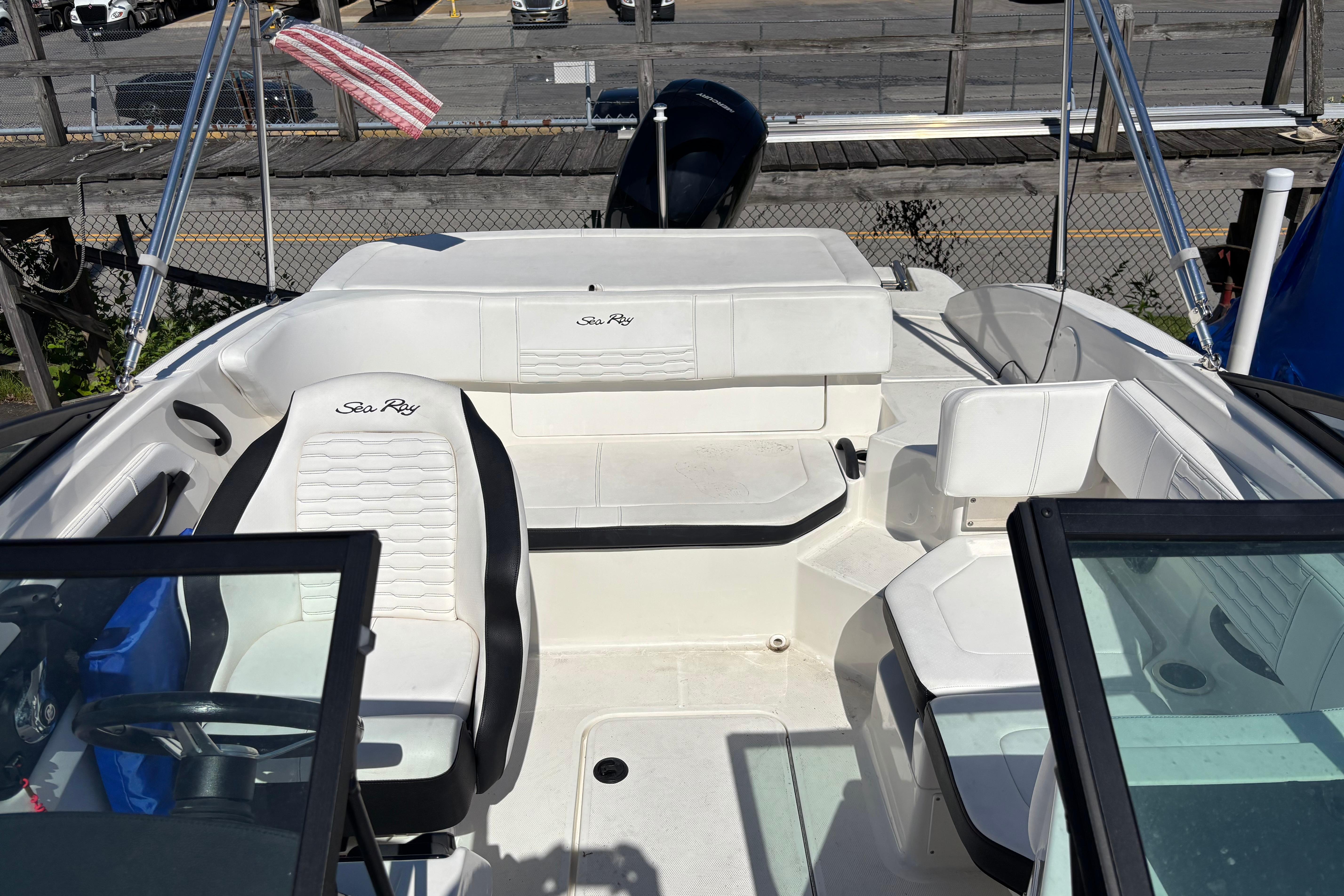 2022 Sea Ray SPX 190 Outboard boat interior with white seating and steering wheel.