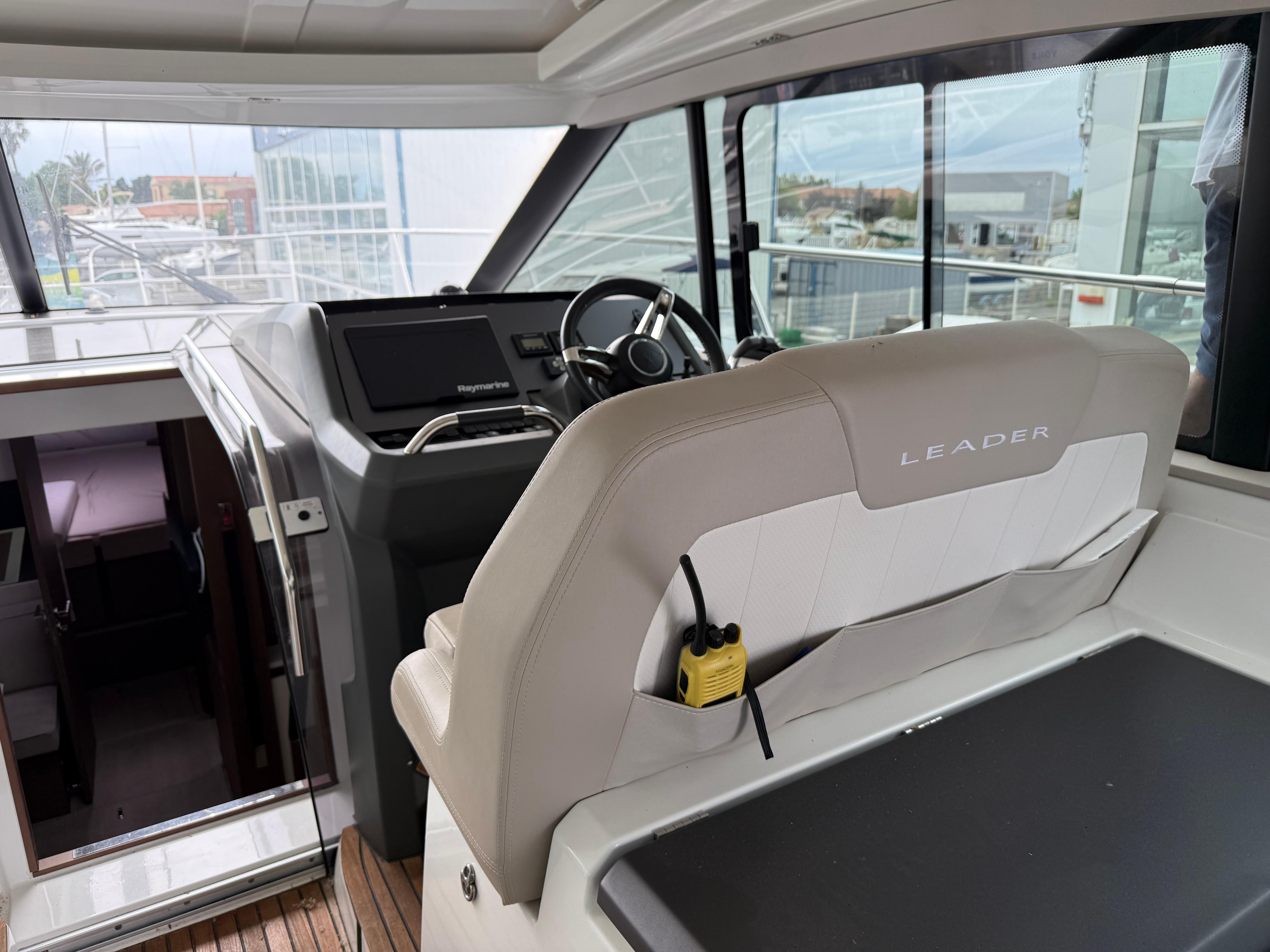 2018 Jeanneau Leader 46 yacht cockpit with steering wheel and seating area.