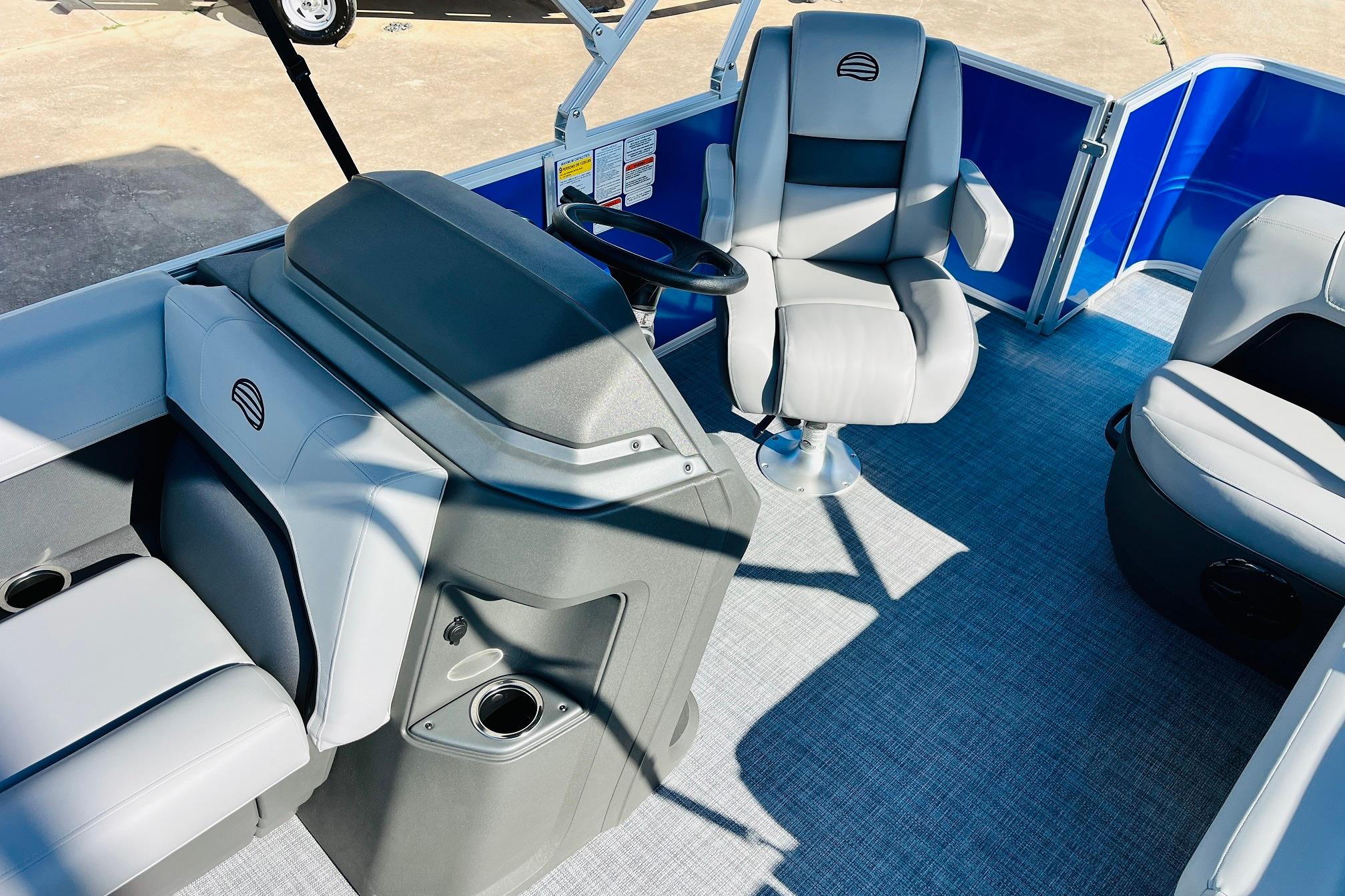 2026 Sun Tracker Party Barge 18 DLX interior with seating and steering console.