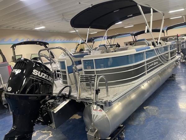 2025 South Bay LE pontoon boat with Suzuki 150 engine in showroom.