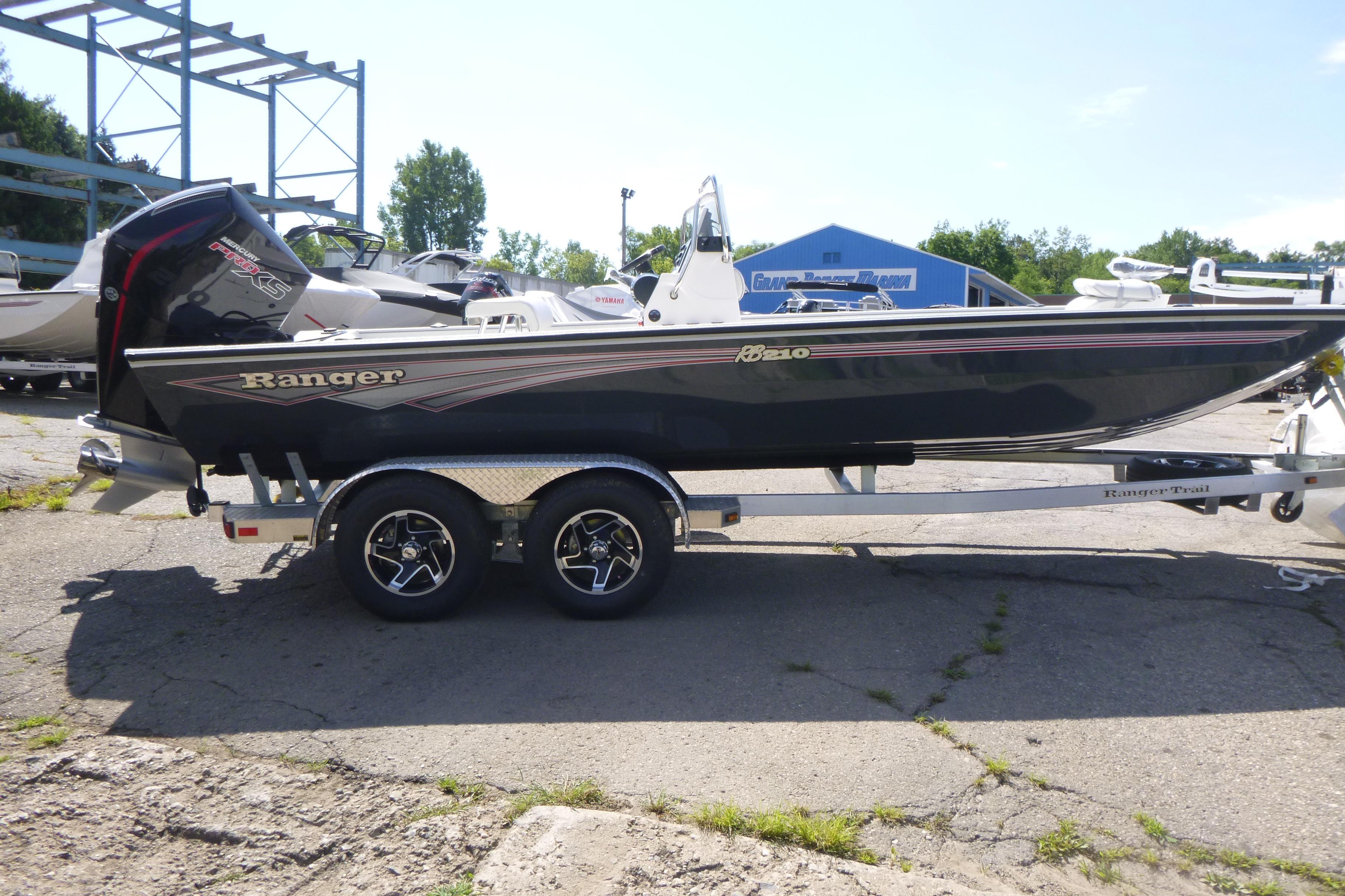 2025 Ranger RB210 boat on trailer, parked outdoors in a marina setting.