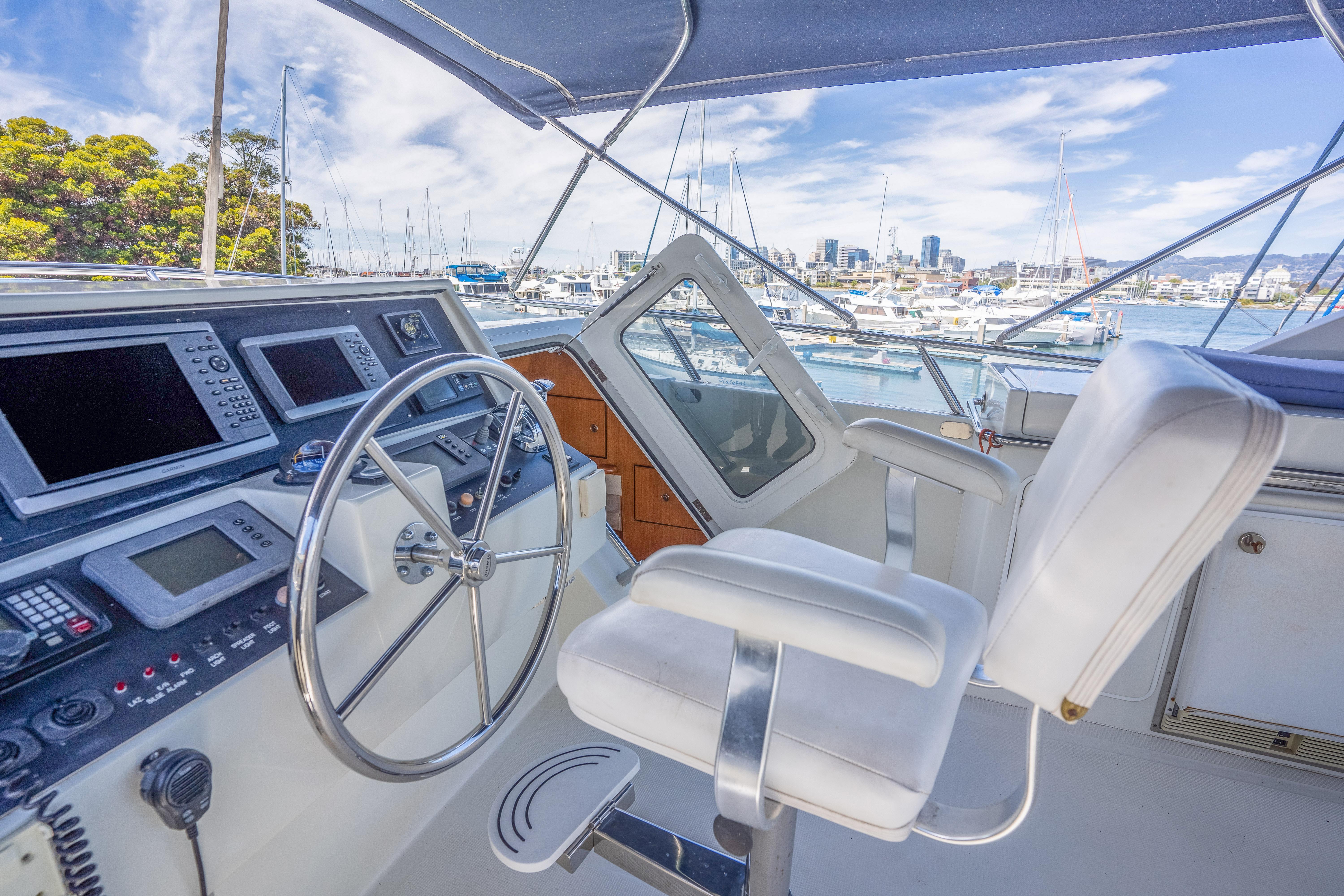 Helm of a 2002 Symbol 58 yacht docked in marina.