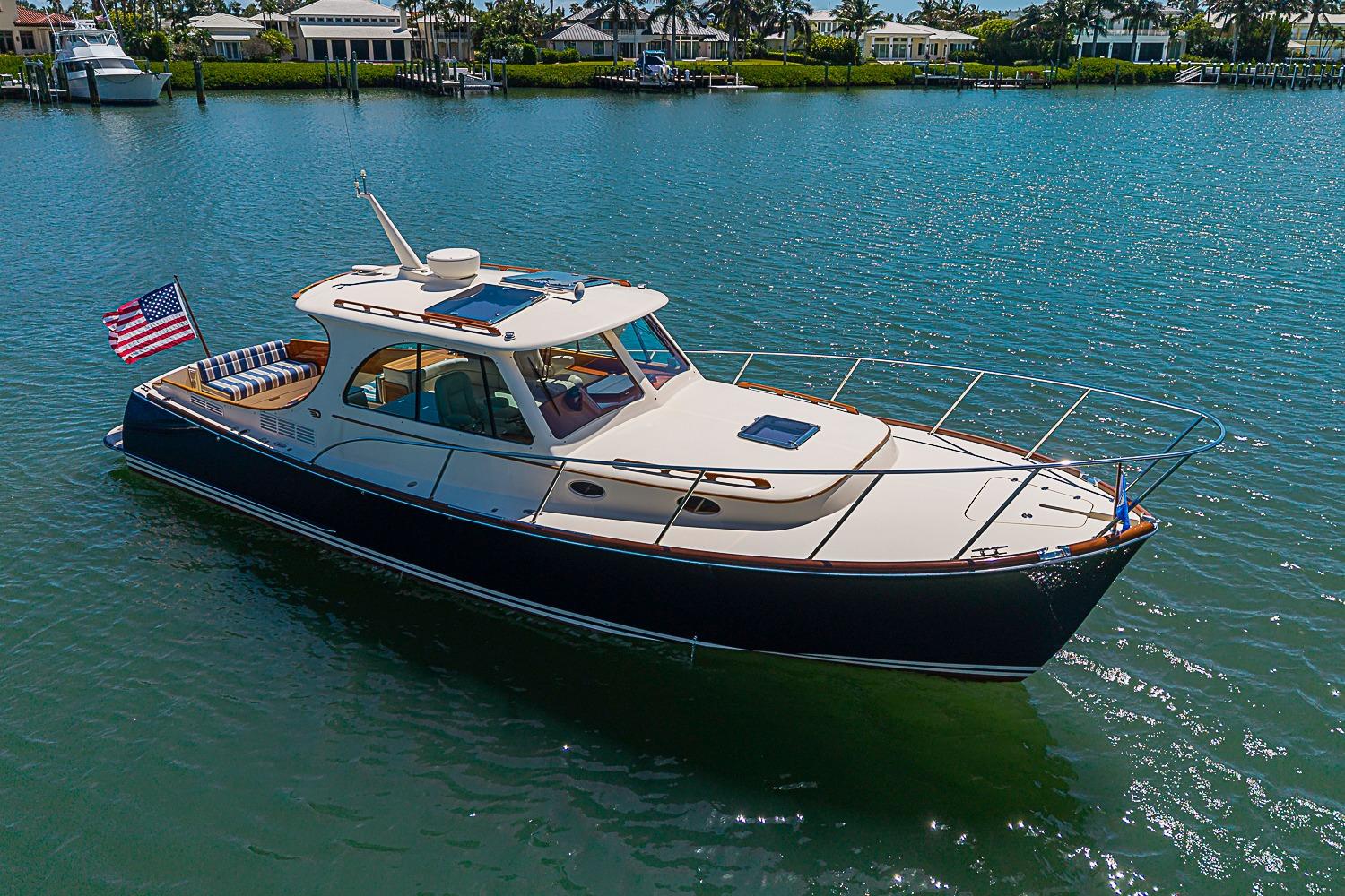 2016 Hinckley Picnic Boat 37 MKIII cruising on a sunny day in calm waters.