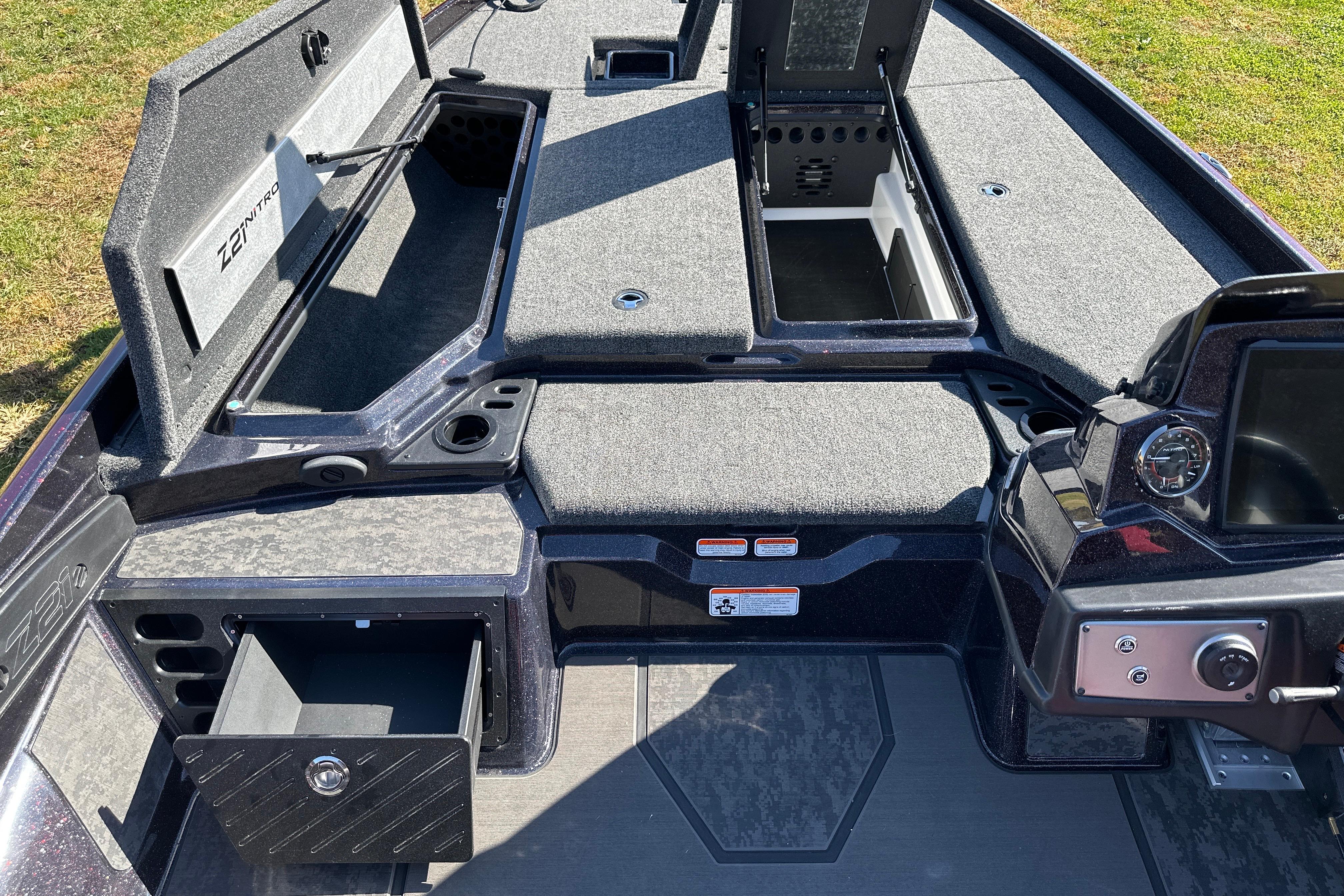 2026 Nitro Z21 XL Pro boat interior with open storage compartments and control panel.