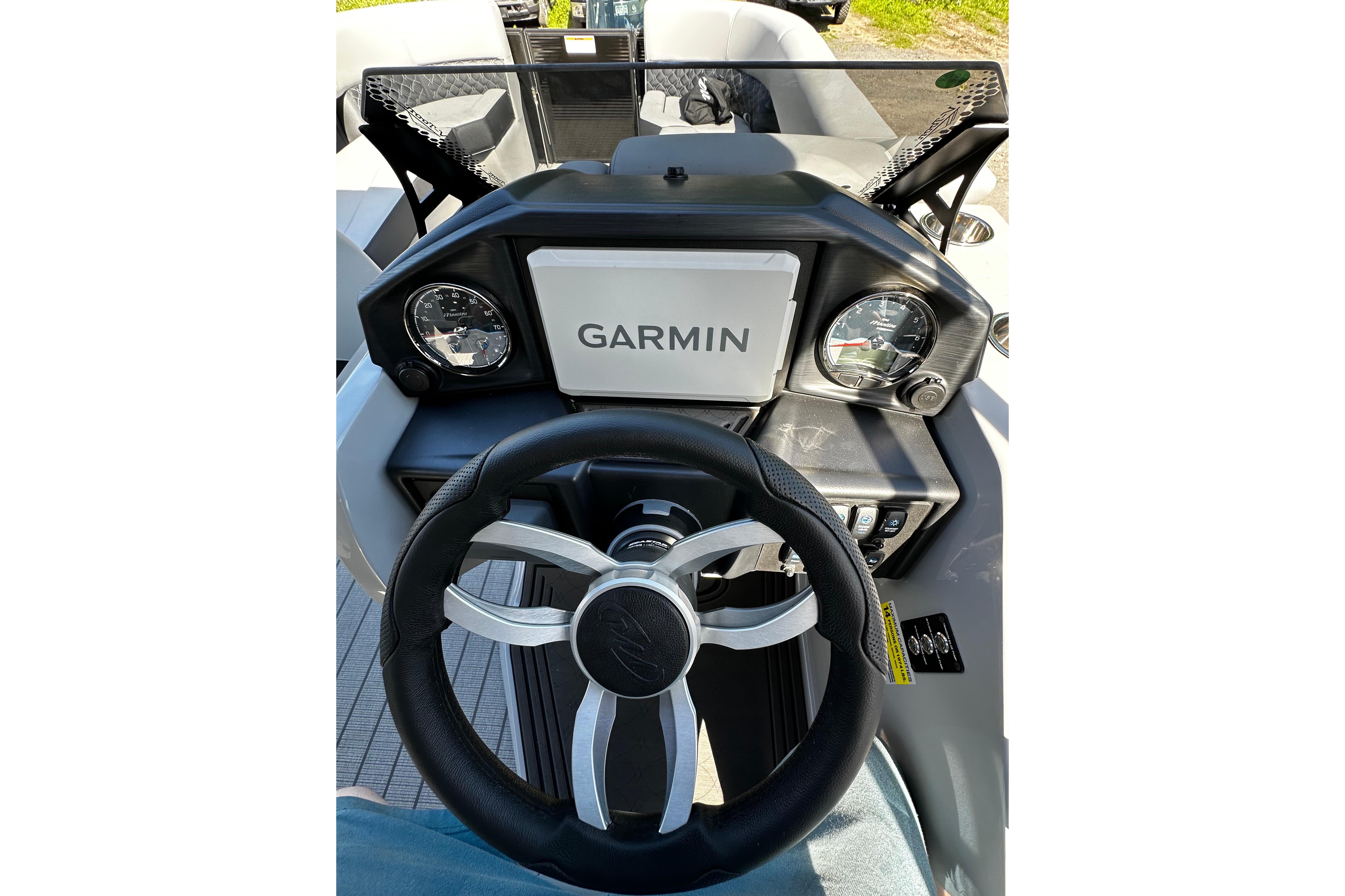 Steering console of 2027 Manitou 25 Encore RF with Garmin display and gauges.