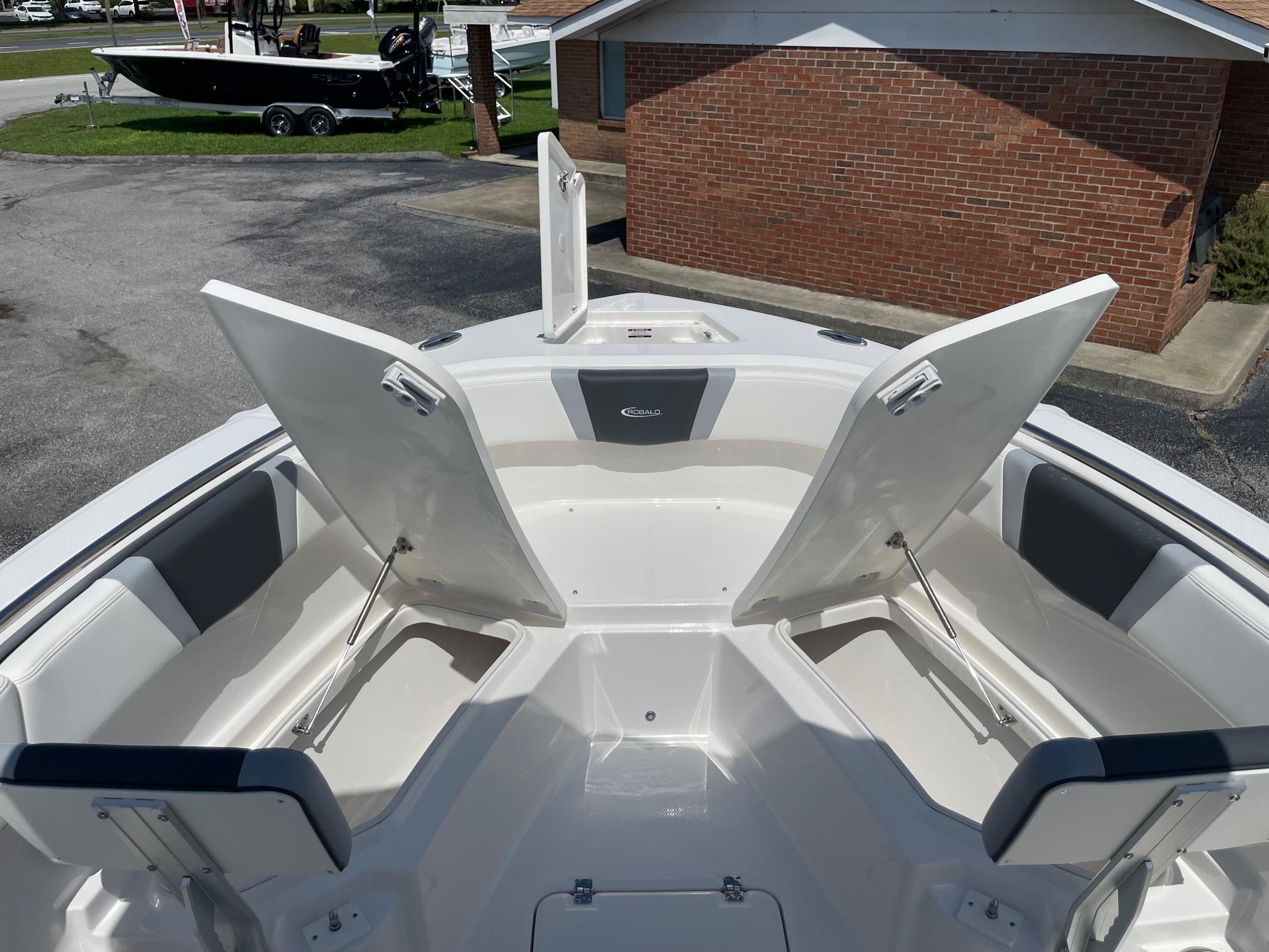 2025 Robalo R230 Center Console boat with open storage compartments and seating.