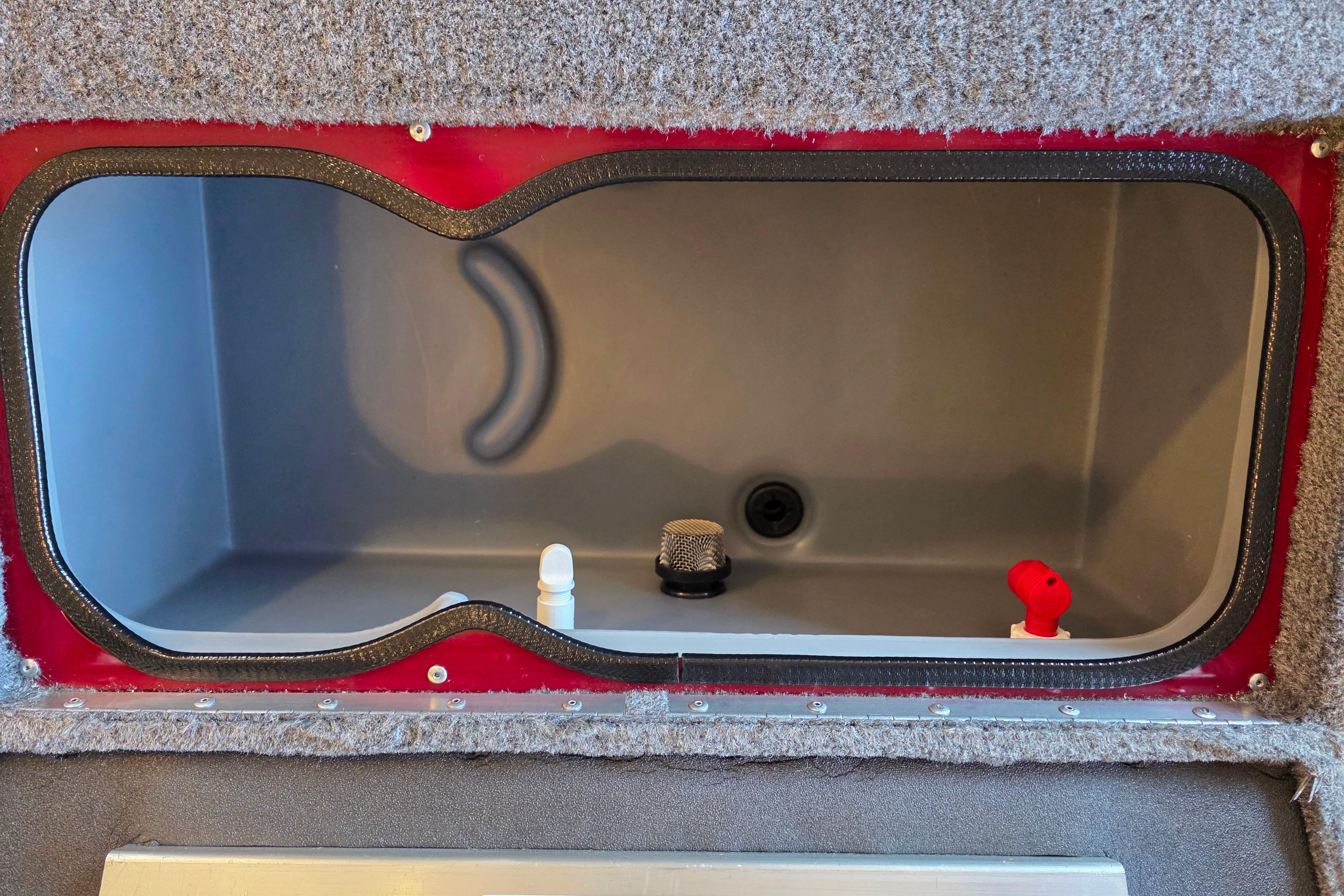 Storage compartment of 2026 Ranger VS1782SC Reata boat, featuring interior fittings and carpeted edges.