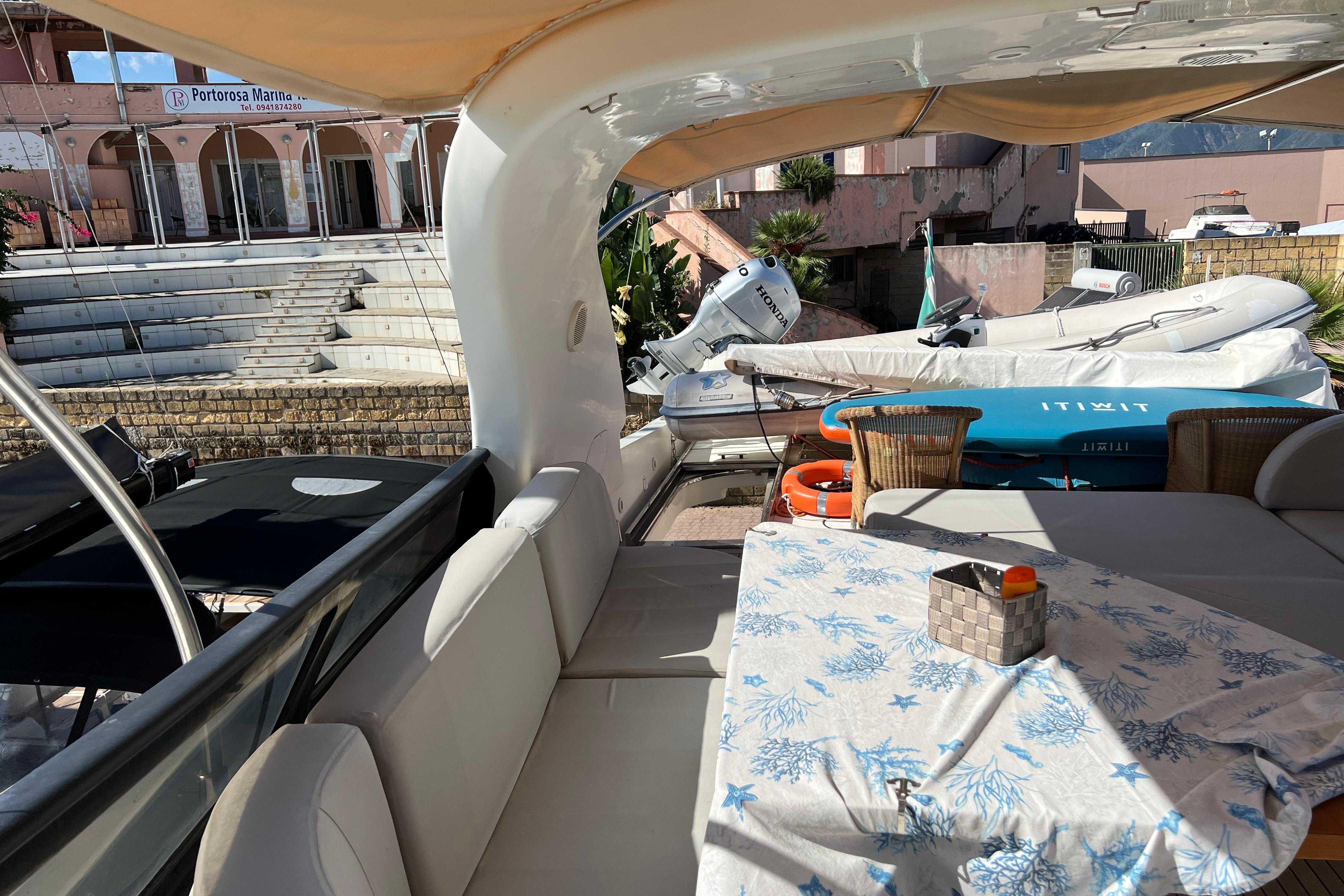 Luxurious 2001 Maiora 24 yacht interior with seating and table at Portorosa Marina.