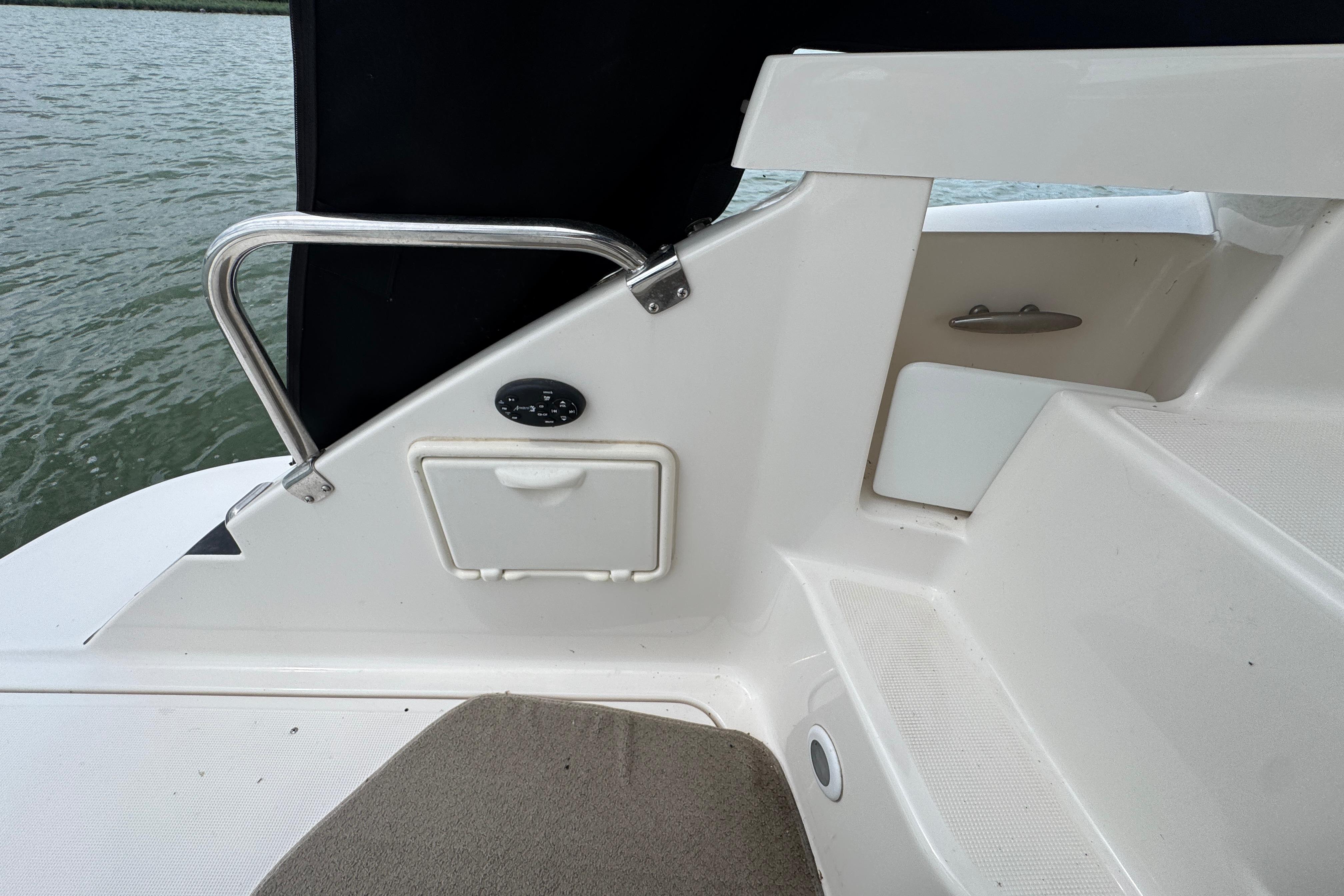 2005 Regal Commodore 4260 boat interior with seating and railing by the water.
