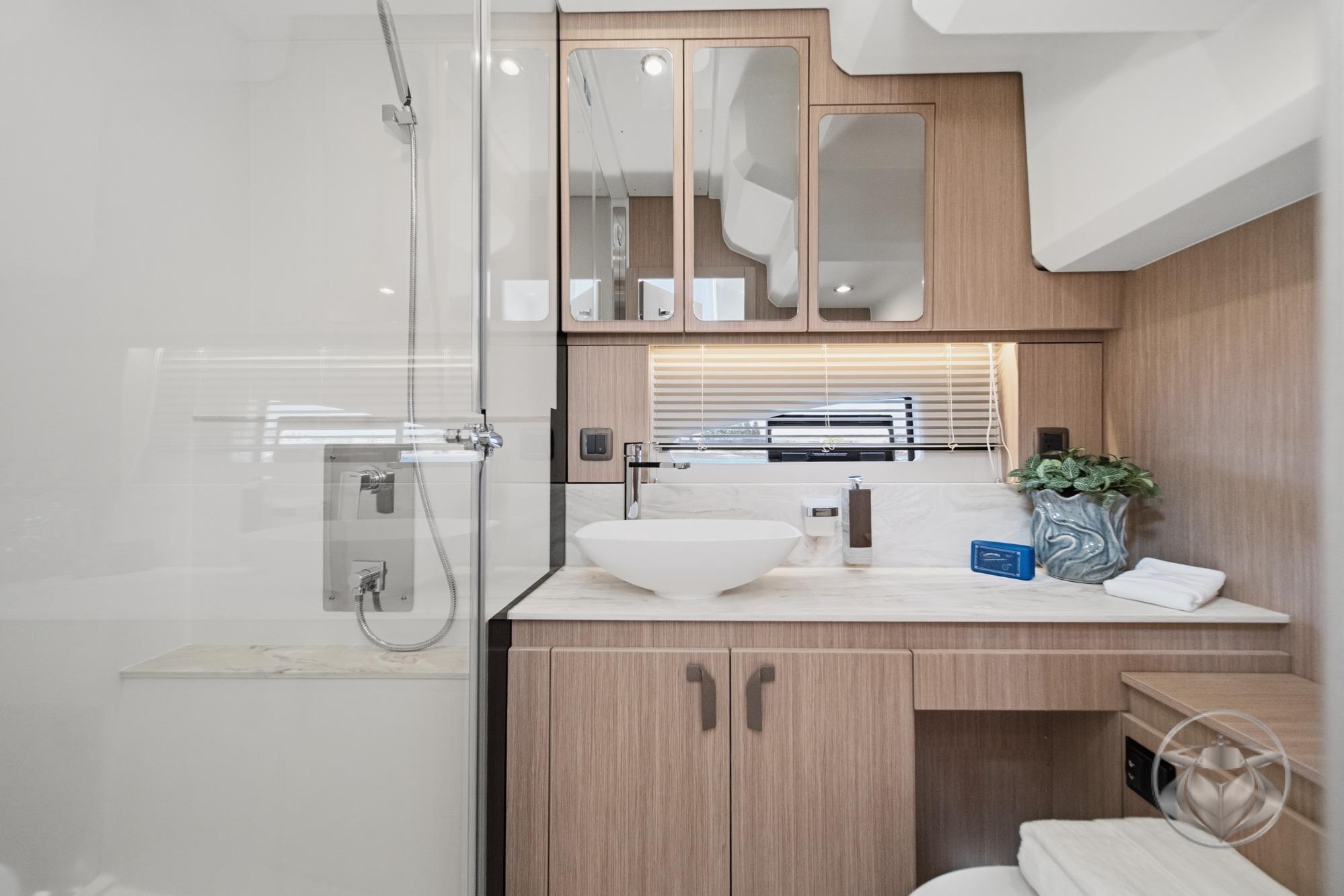 Modern bathroom in 2026 Prestige F4.9 yacht with sleek fixtures and wooden cabinetry.