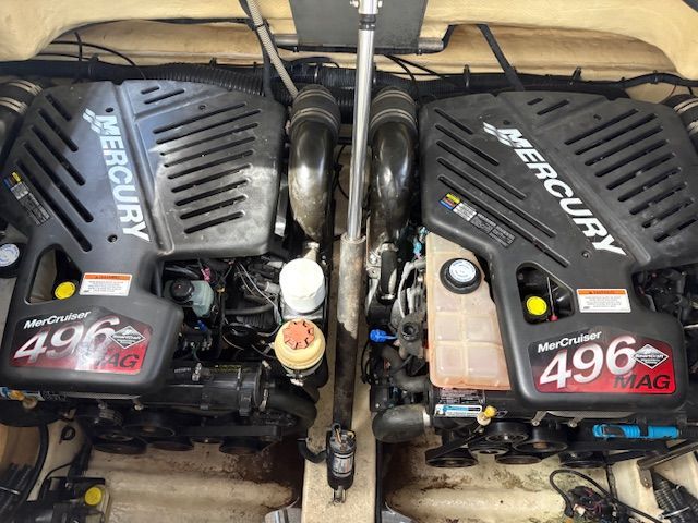 Two Mercury engines in a boat's engine compartment, clean and well-maintained.