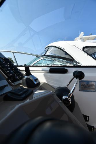 2010 Cruisers Yachts 390 Sports Coupe cockpit with controls and clear blue sky.