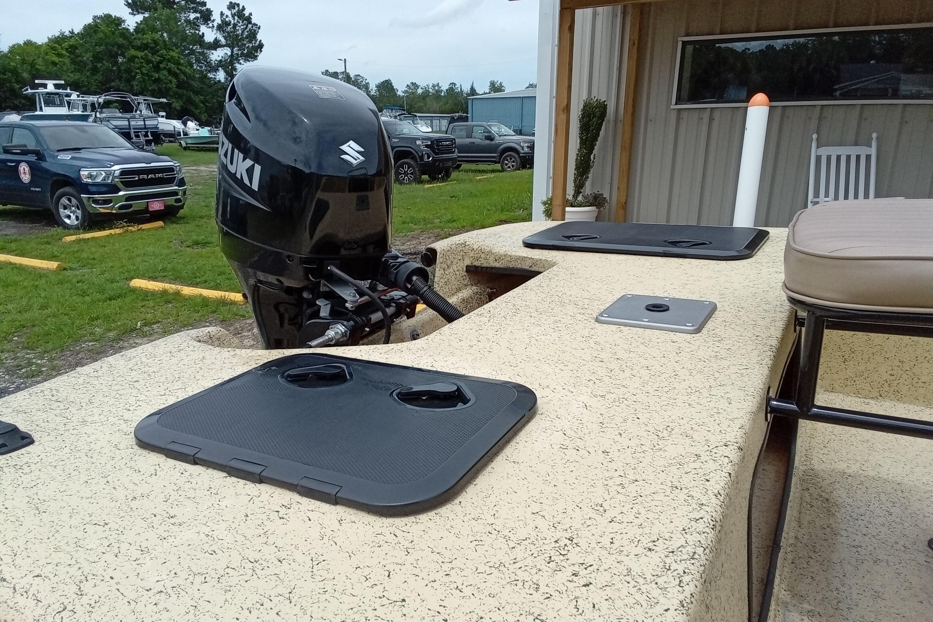 Fibercraft F17 boat with Suzuki outboard motor, parked outdoors, 2025 model.
