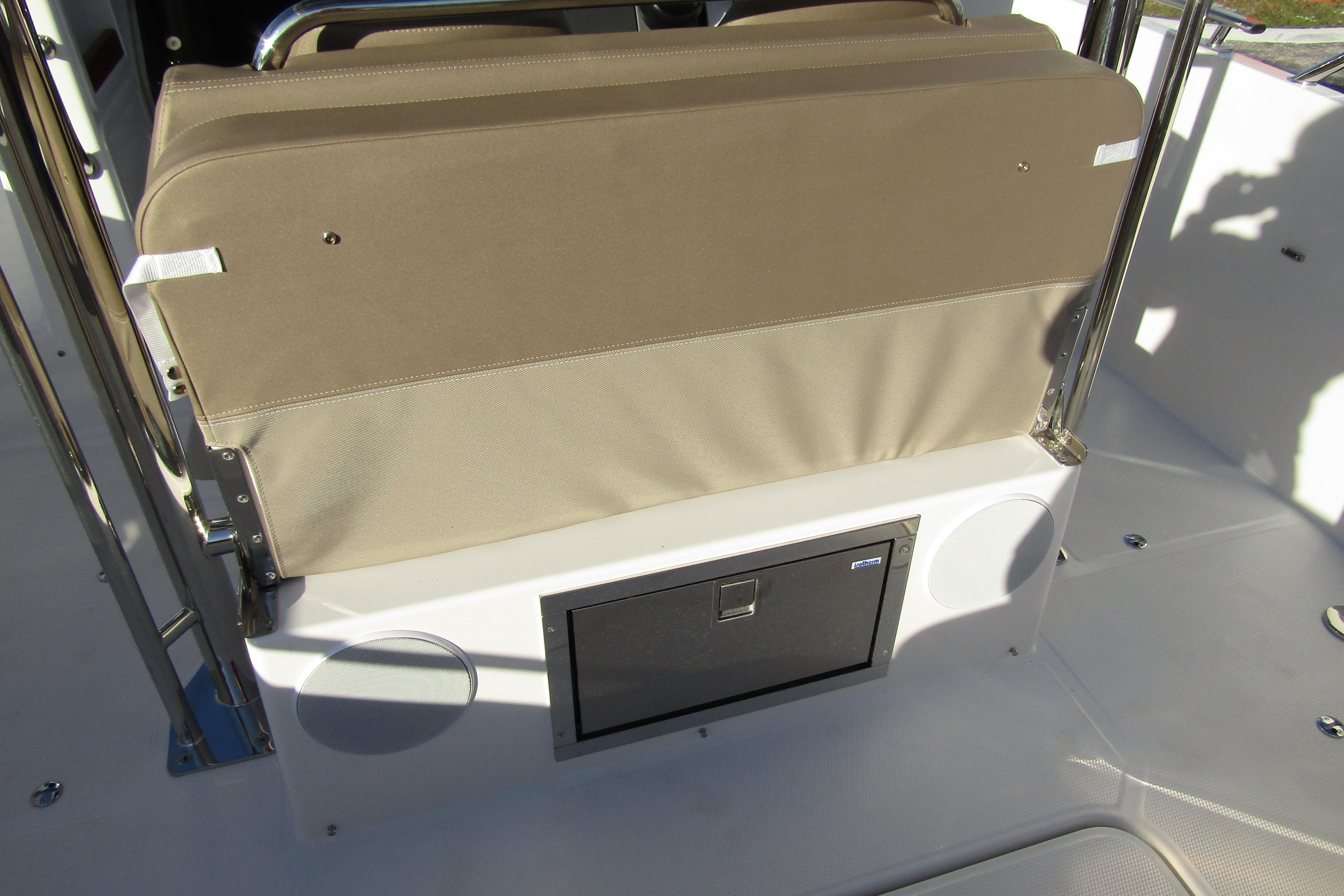 Interior seating of 2025 Nimbus Tender 9 boat with storage compartment.