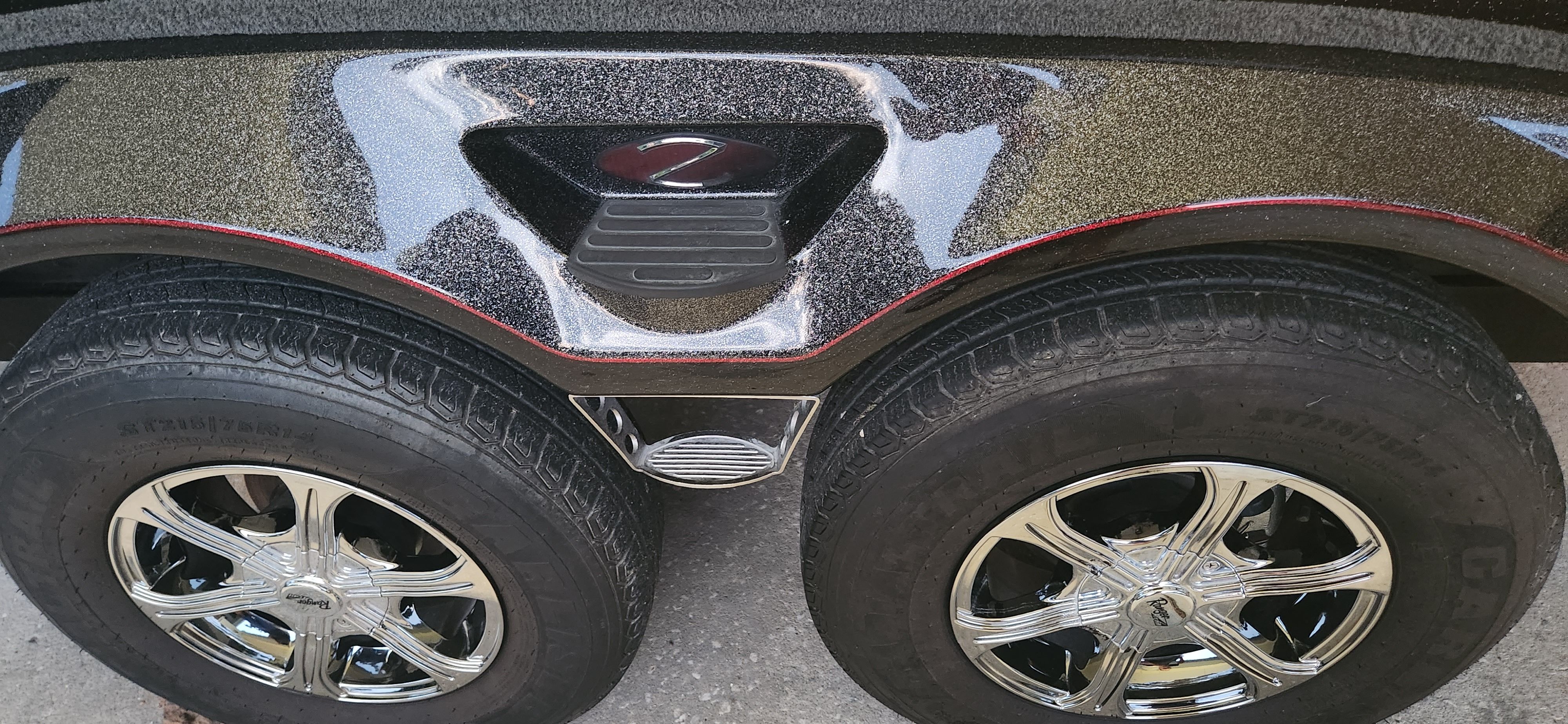 Close-up of the shiny wheels on a Ranger Z520 Comanche boat trailer.