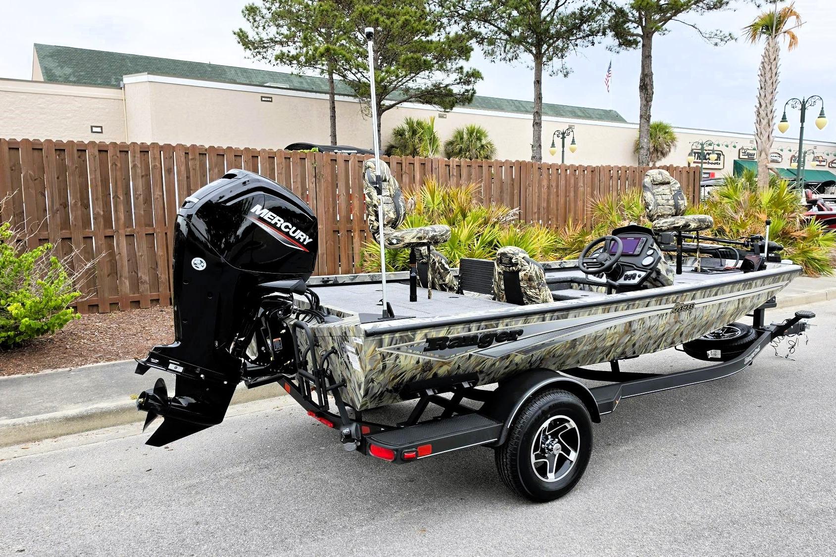 2026 Ranger RT178 fishing boat with camouflage design and Mercury outboard motor on trailer.
