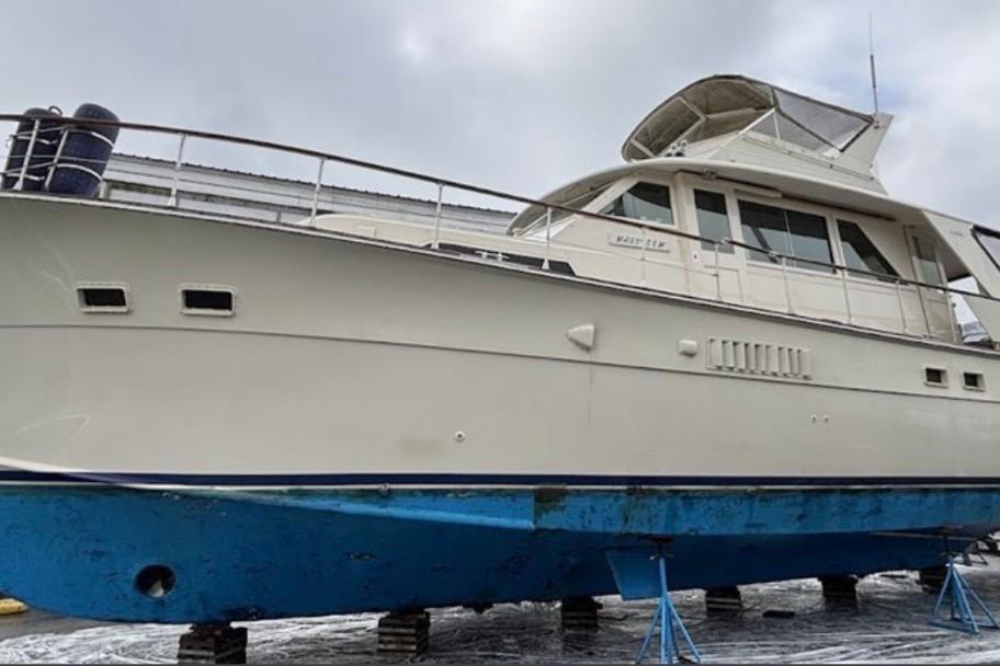 1973 Hatteras 58 Yacht Fisherman on dry dock, showcasing classic design and structure.