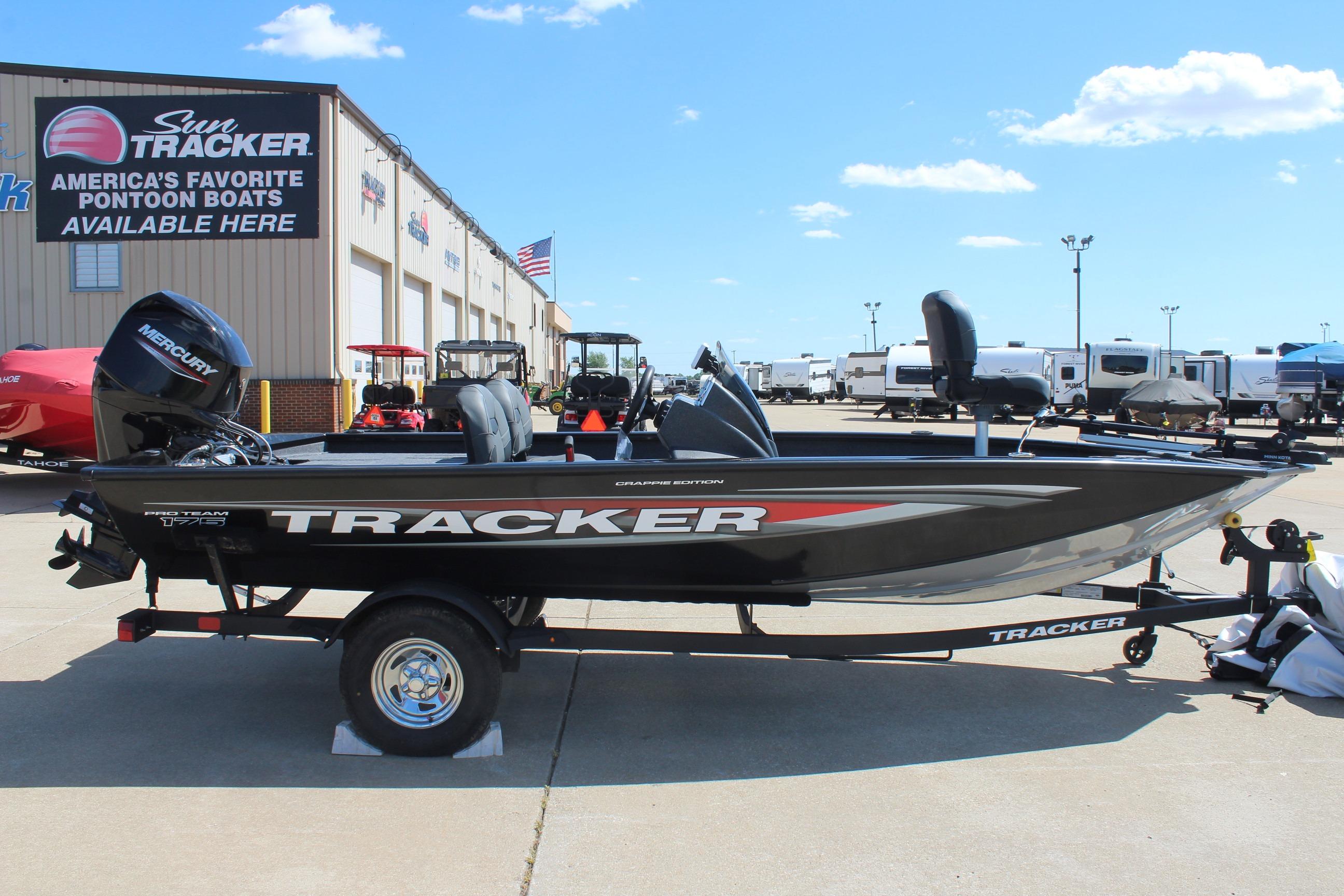 2026 Tracker Pro Team 175 Crappie Edition boat displayed at dealership under clear sky.