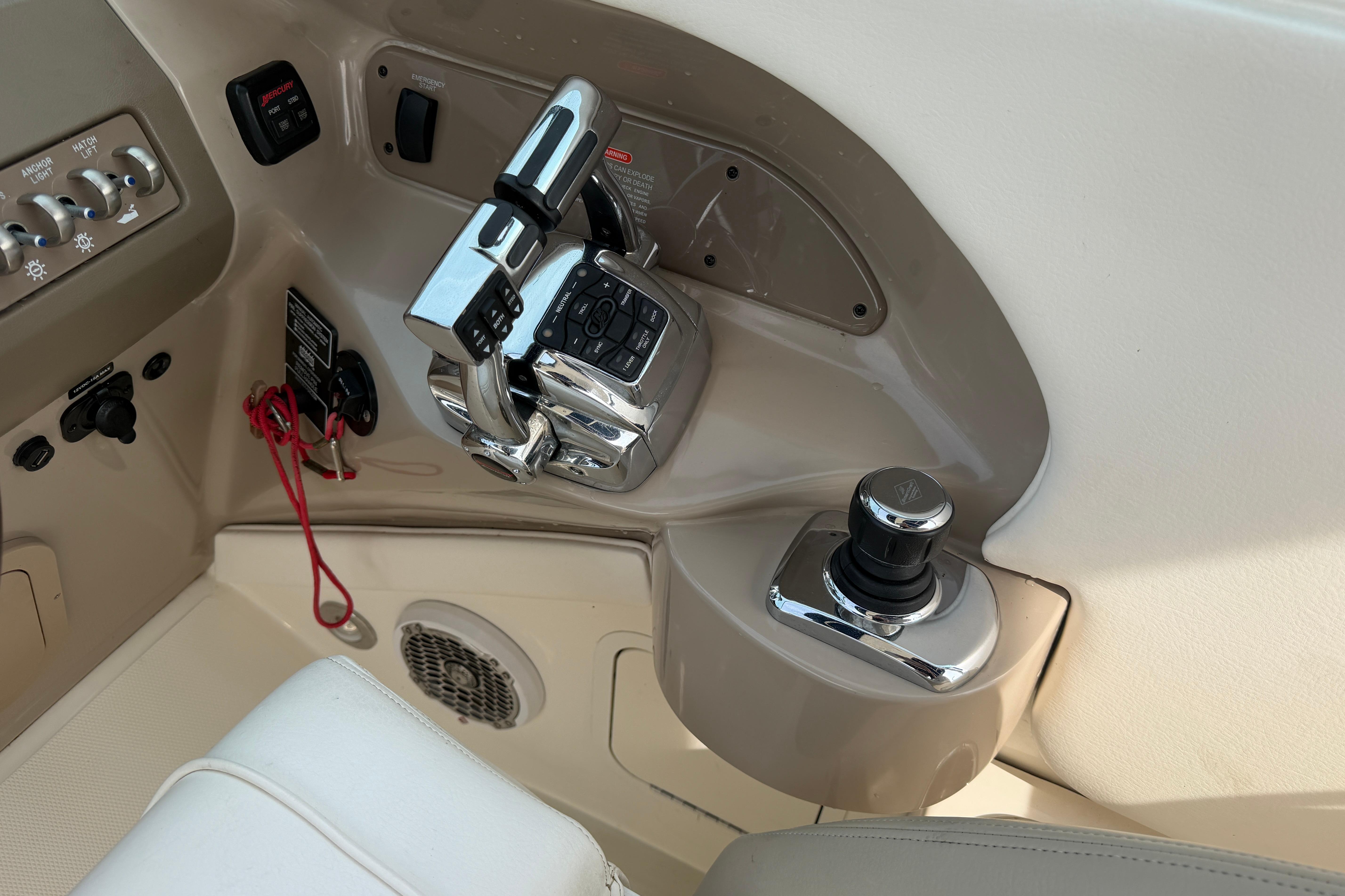 Control panel of a 2013 Sea Ray 300 SLX boat, featuring throttle and joystick controls.