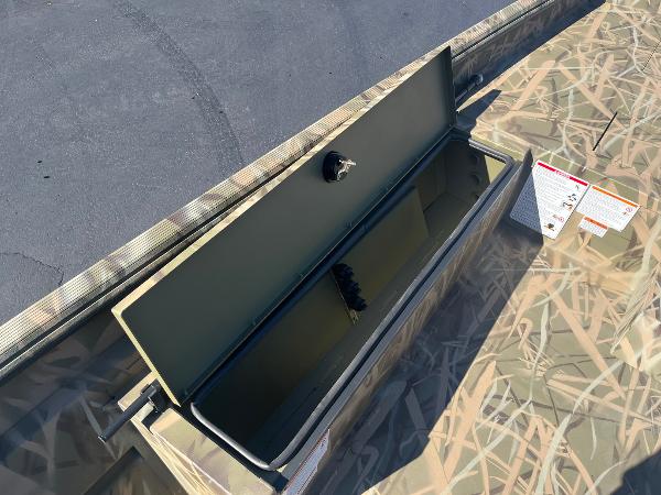 2025 Lowe Roughneck 2070 SC boat storage compartment with camouflage design.