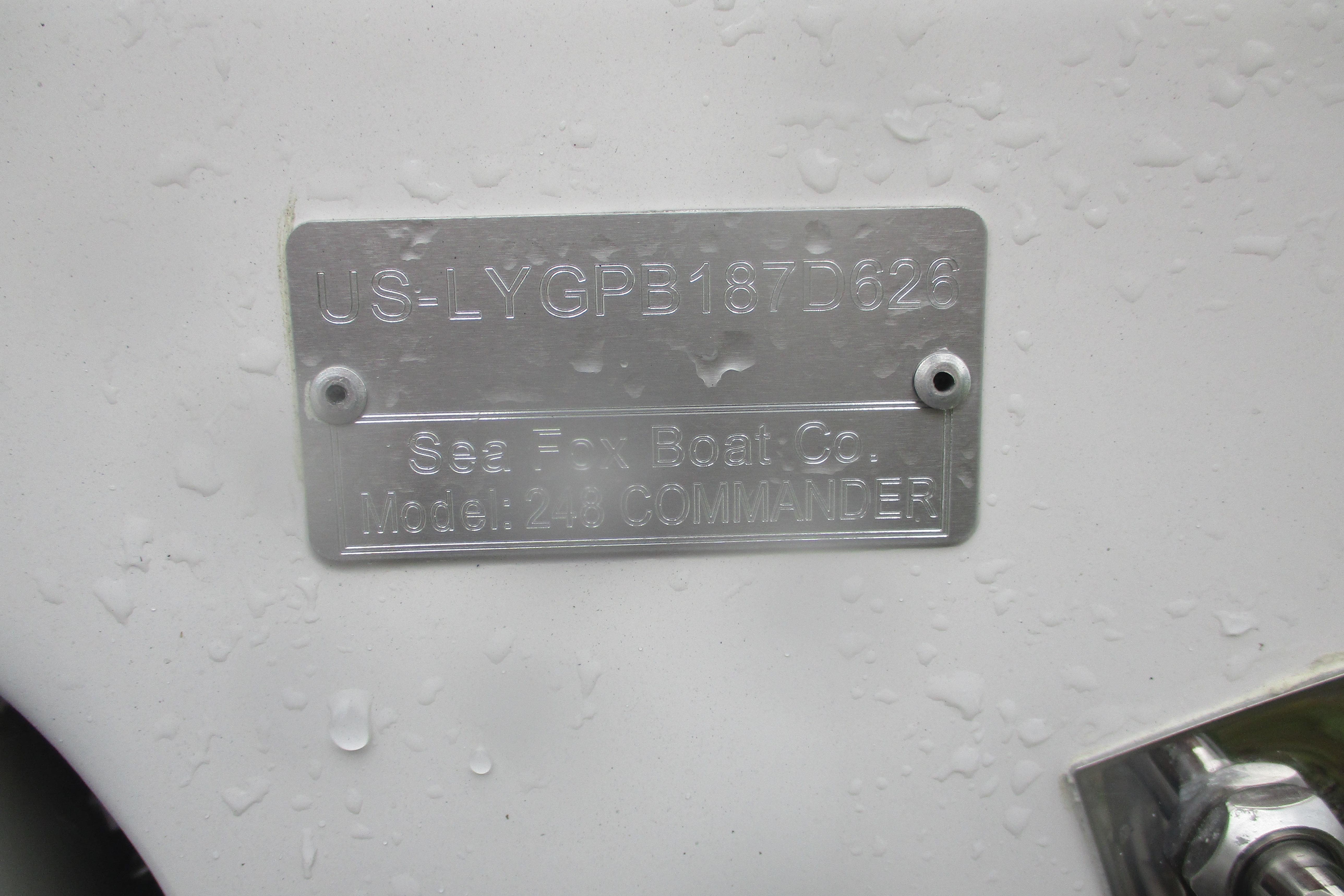 Metal identification plate on 2026 Sea Fox 248 Commander boat, wet surface.