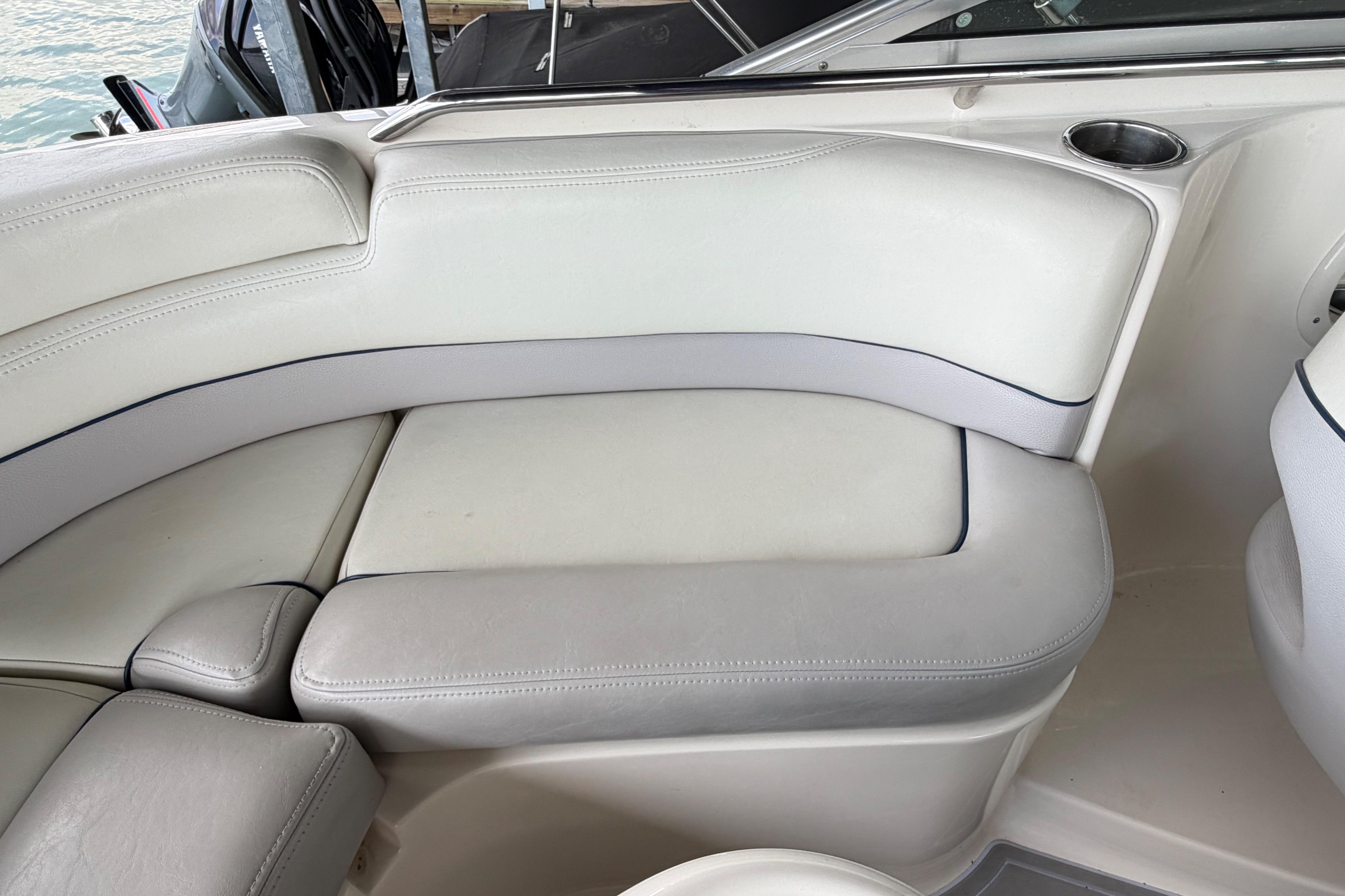 Interior seating of a 2010 Bryant 255 boat with white upholstery.
