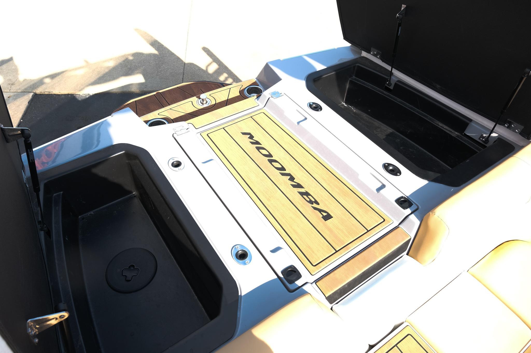 2023 Moomba Mondo boat storage compartments with open hatches and branded flooring.