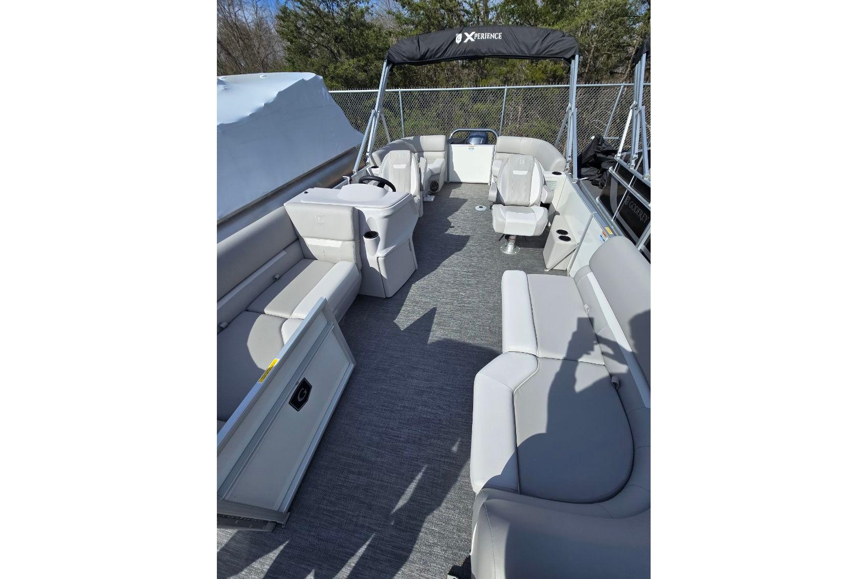 2025 Godfrey Xperience 2086 SBX pontoon boat interior with gray seating and helm.
