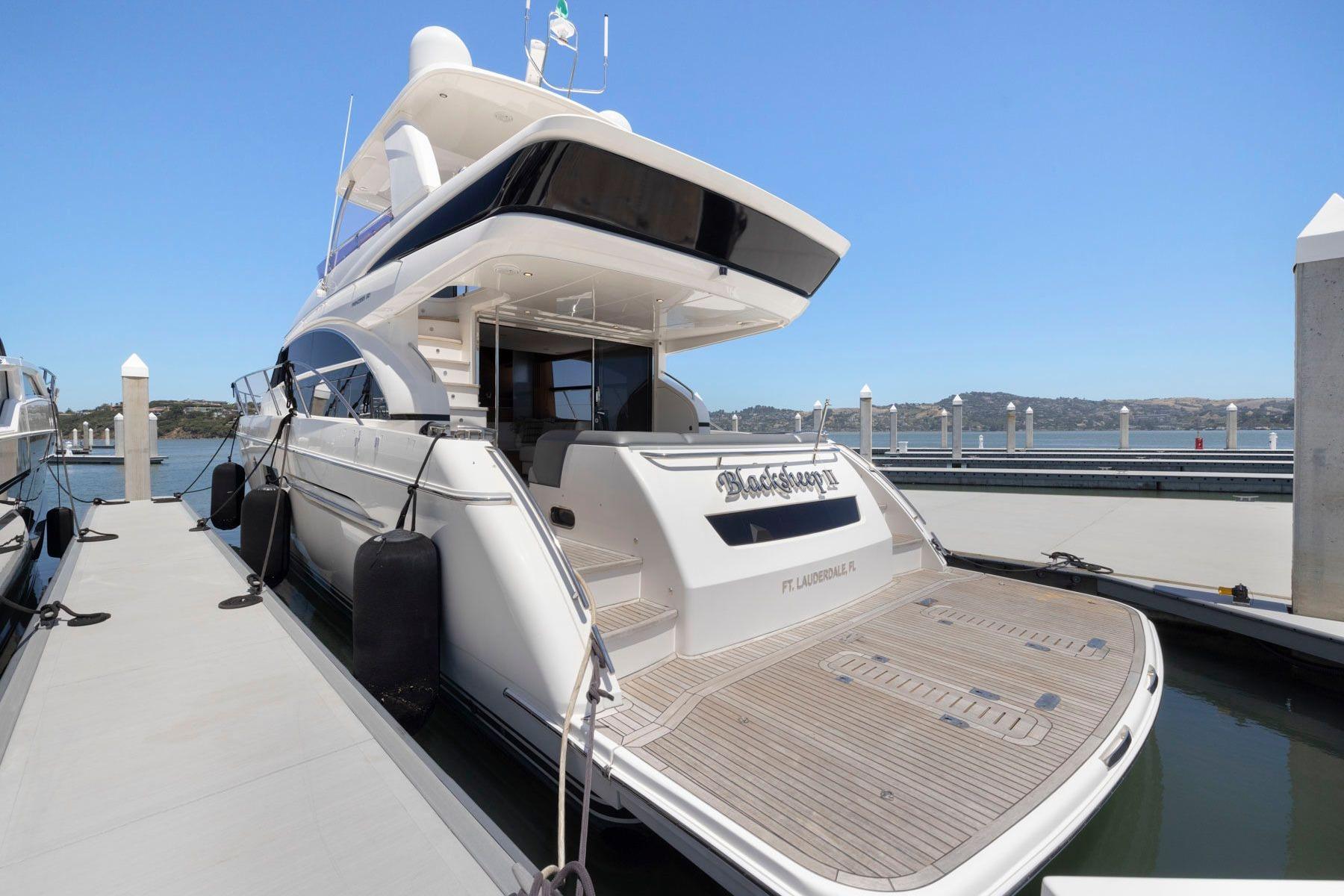 2015 Princess 60 Flybridge Motor Yacht docked at marina, showcasing elegant design and spacious deck.