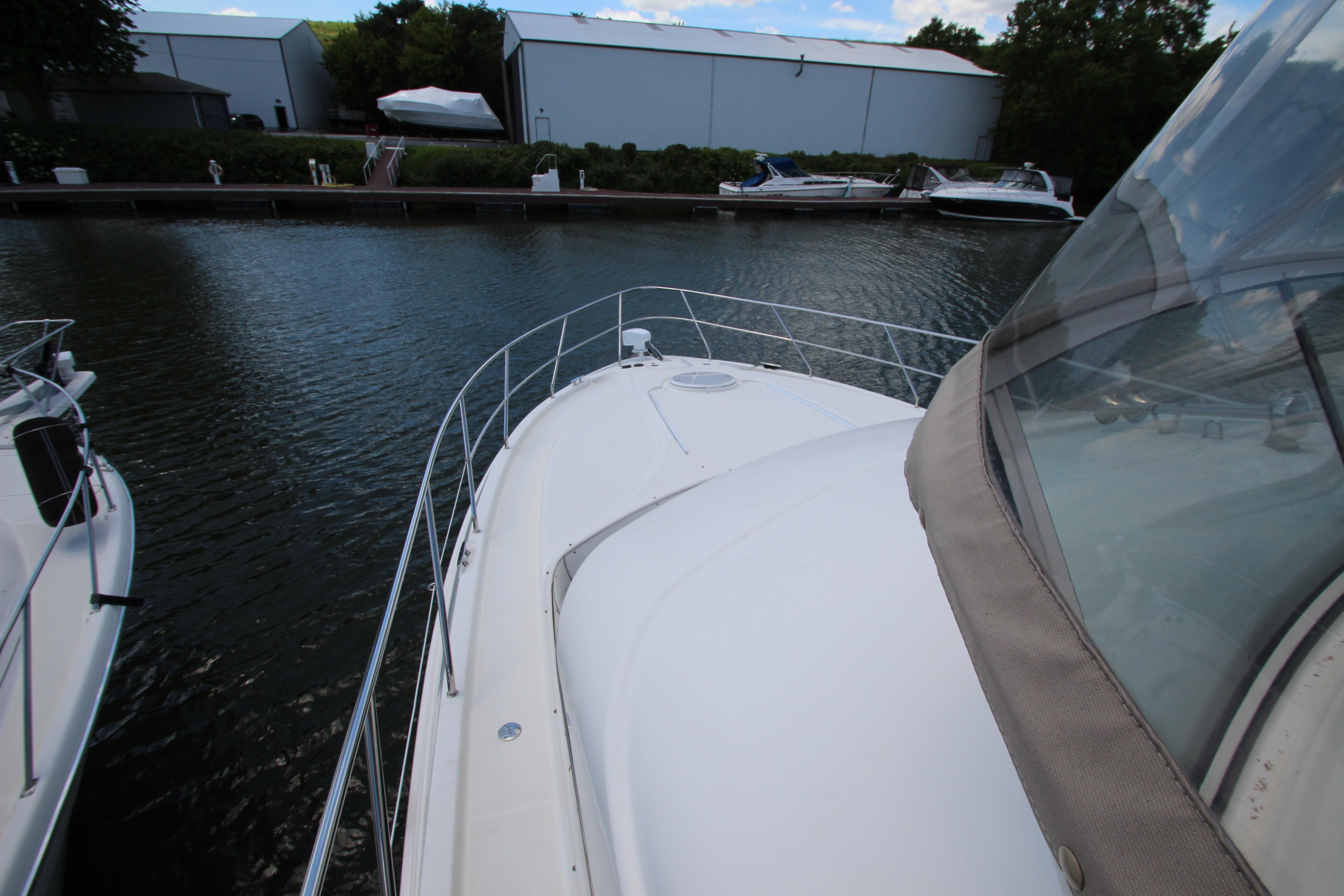 2006 Silverton 38 Sport Bridge yacht docked at marina, view from bow.