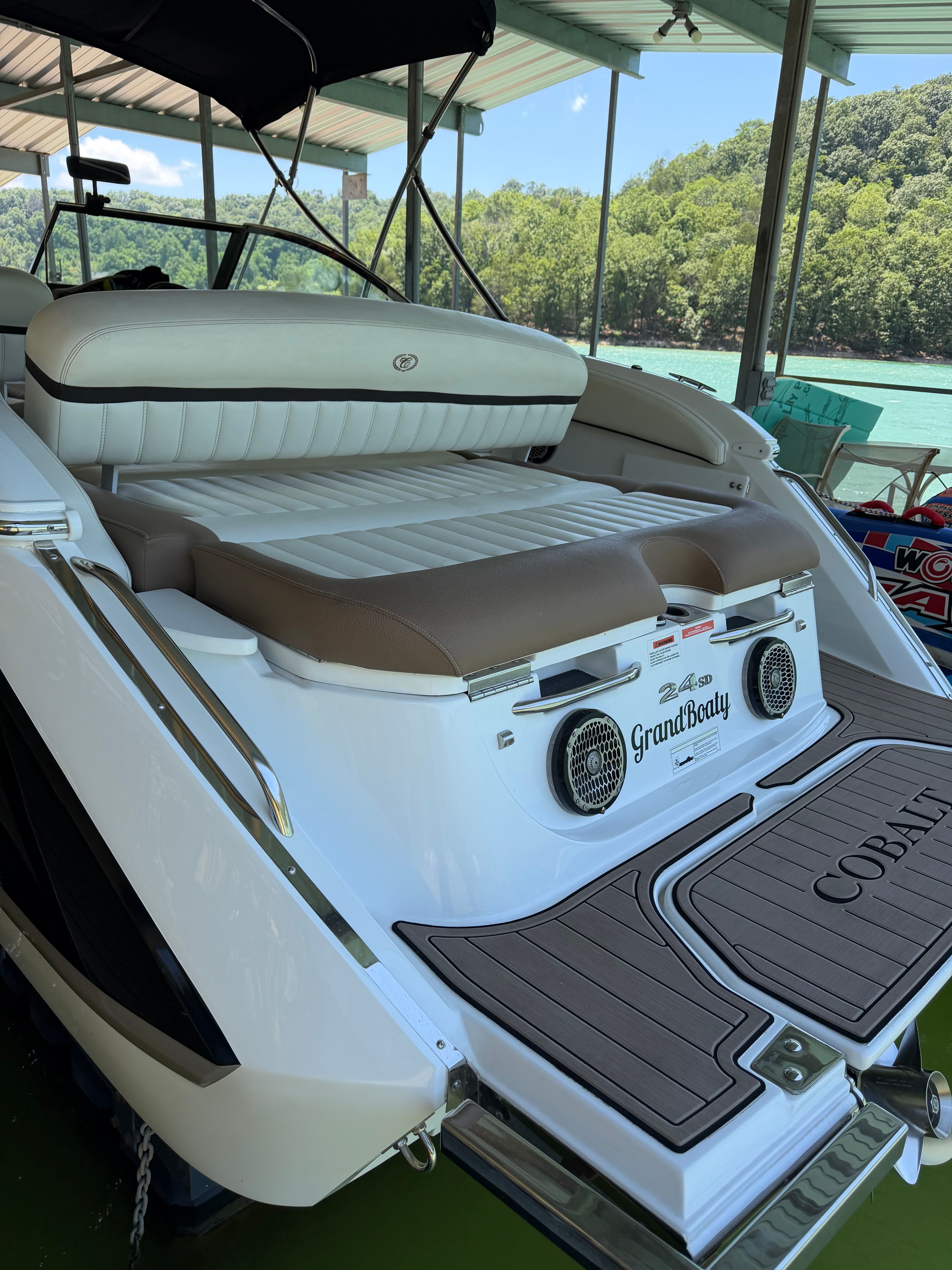 A sleek Cobalt boat with comfortable seating and modern design, docked in a covered area.