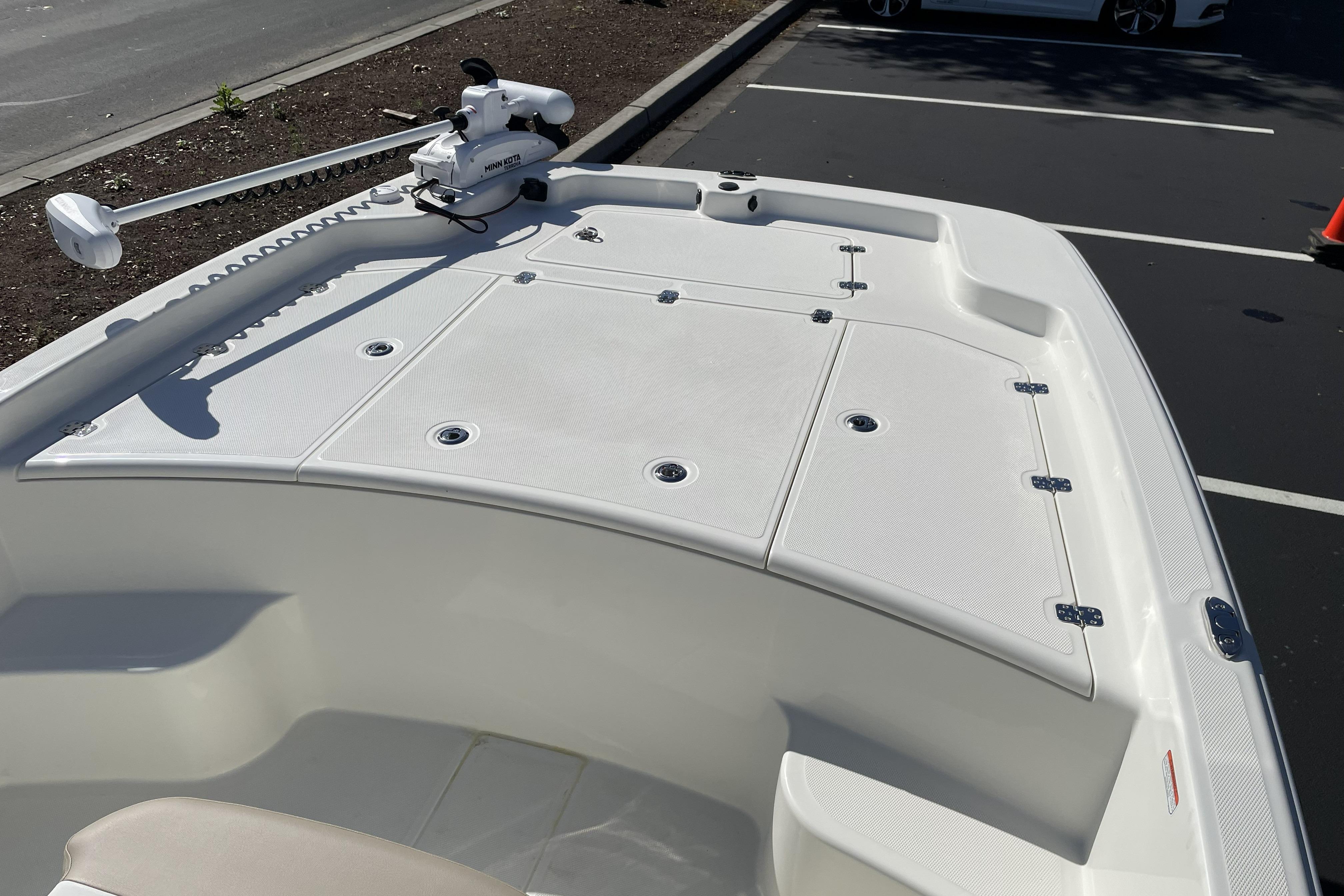 2026 Mako Pro Skiff 19 CC boat deck with trolling motor in parking lot.