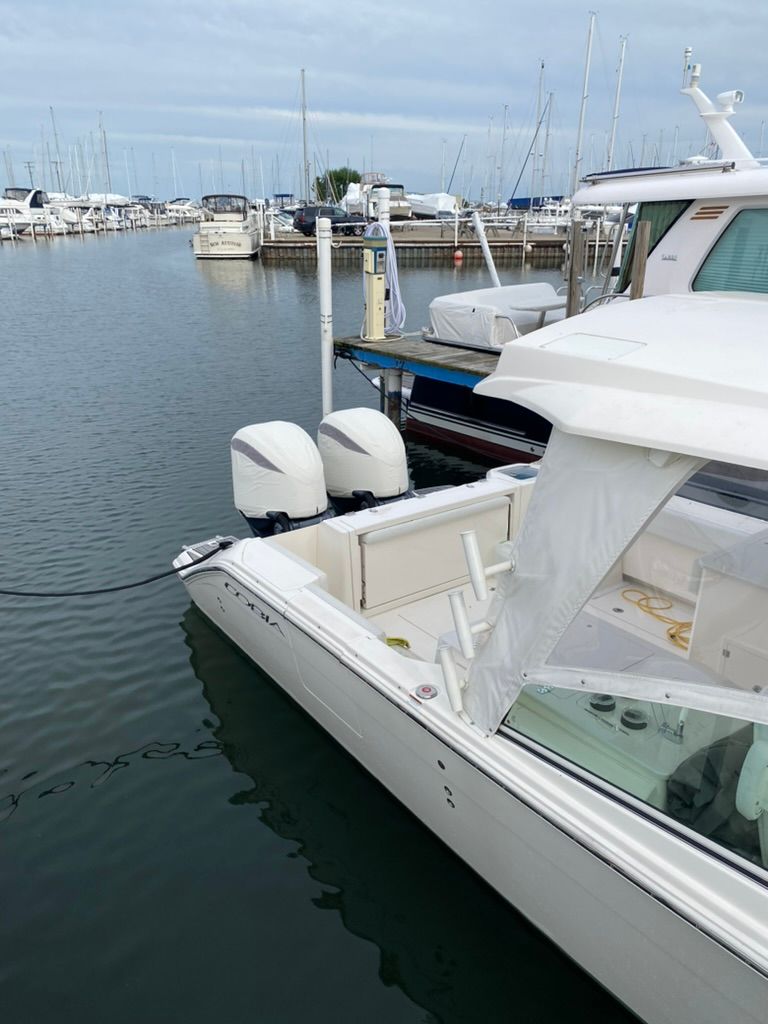 2023 Cobia 330 boat docked at marina.