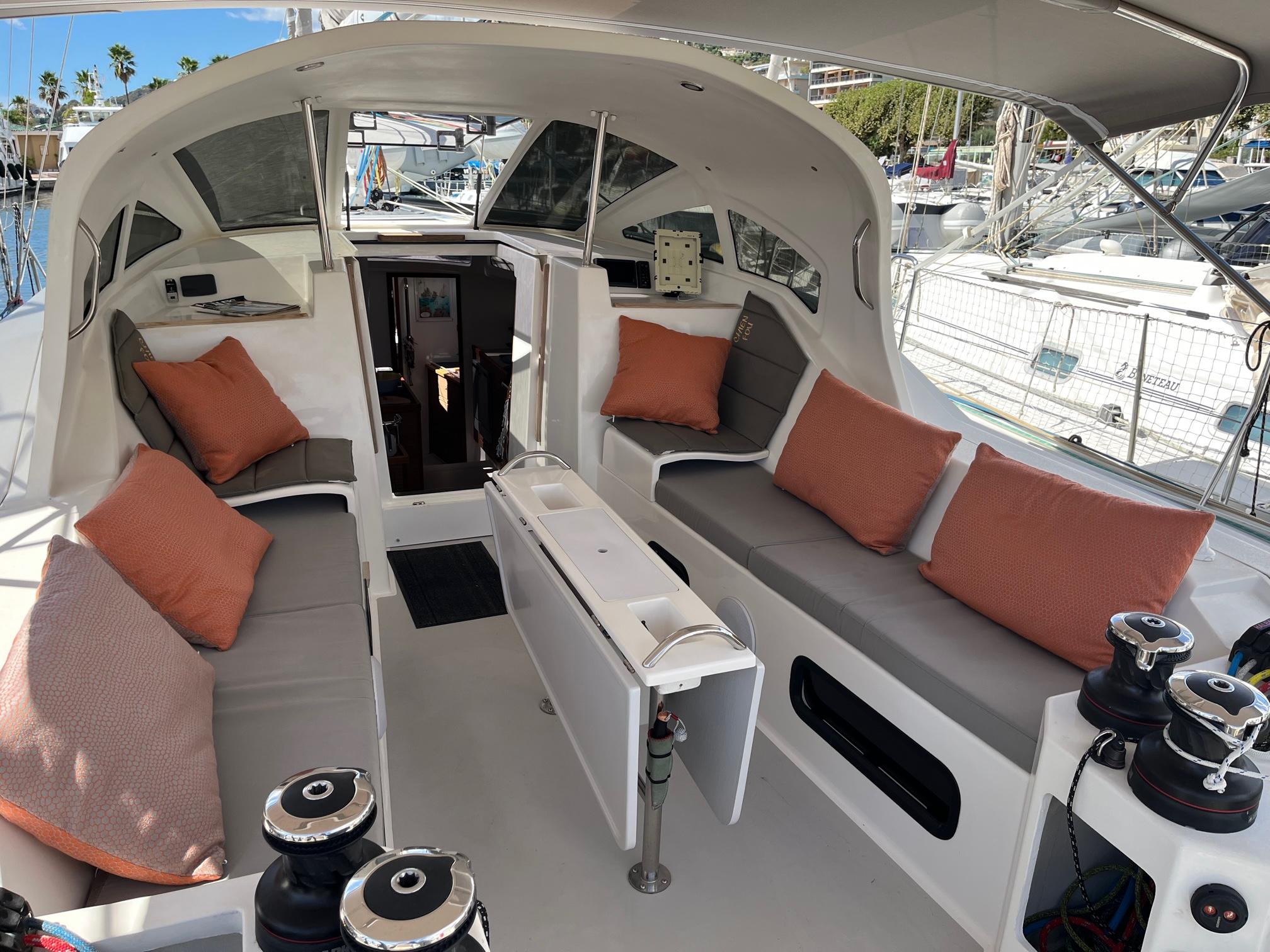 Luxurious 2019 JPK 45 FC yacht interior with cushioned seating and modern design.